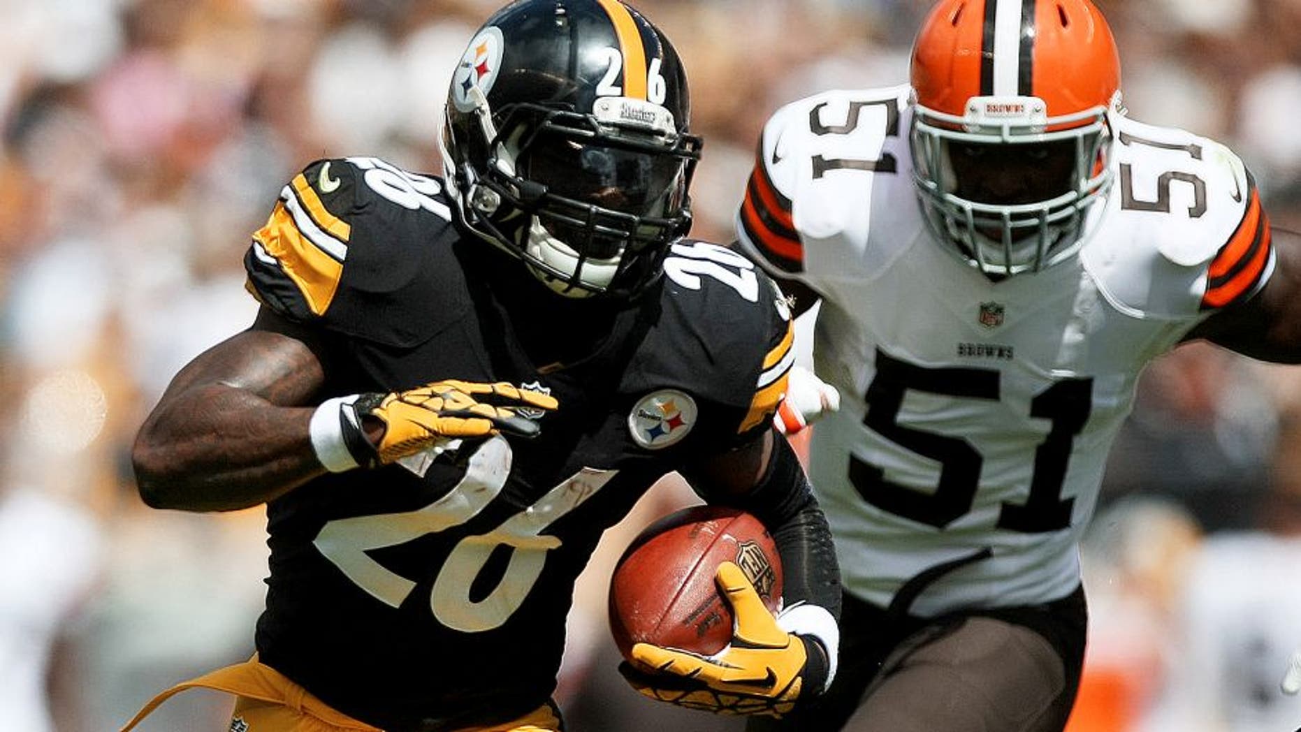 Sep 7, 2014; Pittsburgh, PA, USA; Pittsburgh Steelers running back Le'Veon Bell (26) runs the ball past Cleveland Browns linebacker Barkevious Mingo (51) during the first quarter at Heinz Field. Mandatory Credit: Jason Bridge-USA TODAY Sports