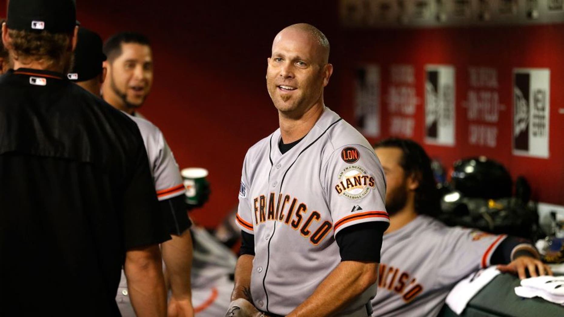 PHOENIX, AZ - SEPTEMBER 08: Tim Hudson #17 of the San Francisco Giants reacts in the duogut after hitting a solo home-run against the Arizona Diamondbacks during the third inning of the MLB game at Chase Field on September 8, 2015 in Phoenix, Arizona. (Photo by Christian Petersen/Getty Images)