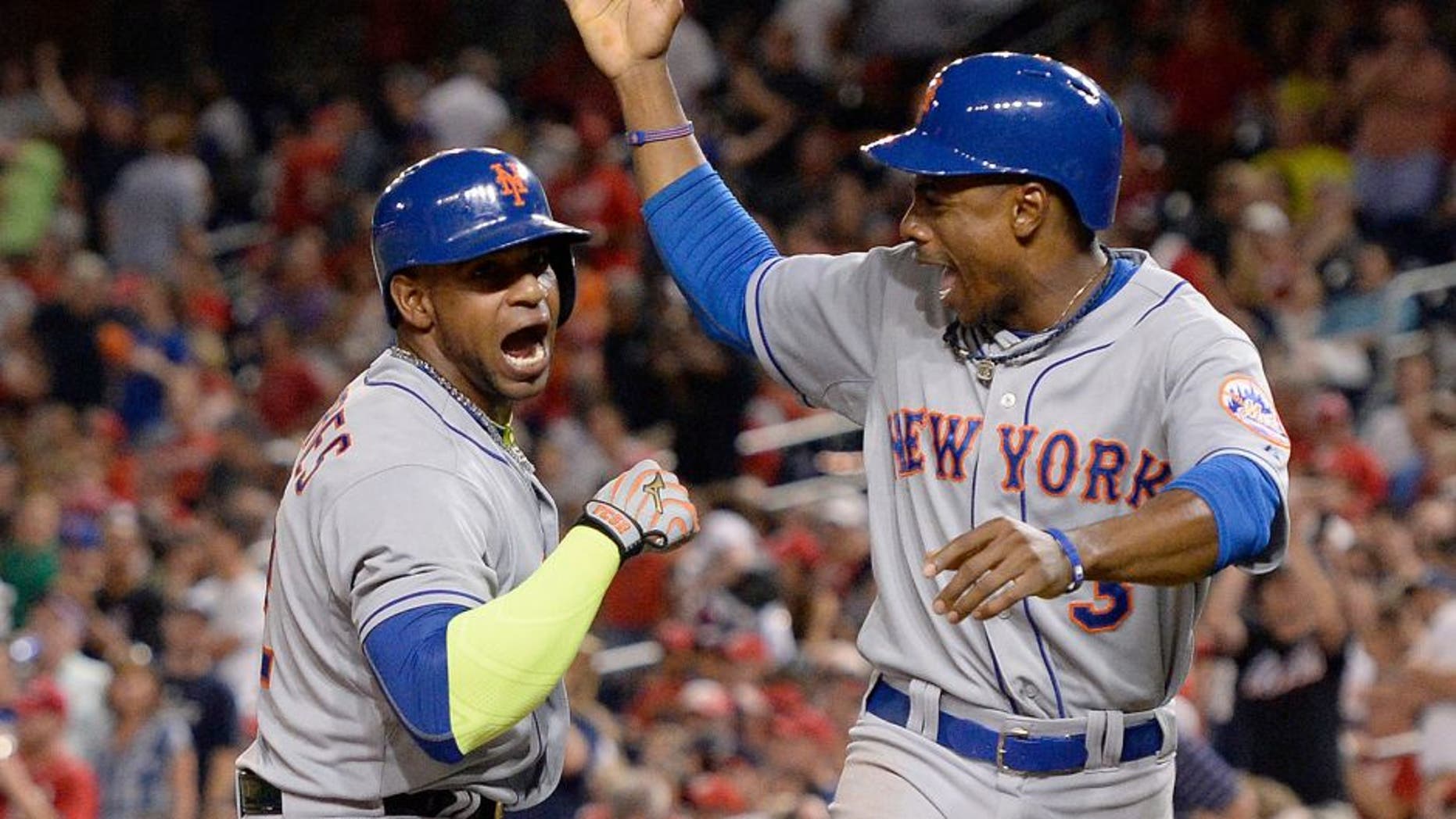 Sep 9, 2015; Washington, DC, USA; New York Mets center fielder Yoenis Cespedes (52) celebrates with right fielder Curtis Granderson (3) after hitting a two run home run in the eighth inning against the Washington Nationals at Nationals Park. New York Mets defeated Washington Nationals 5-3. Mandatory Credit: Tommy Gilligan-USA TODAY Sports
