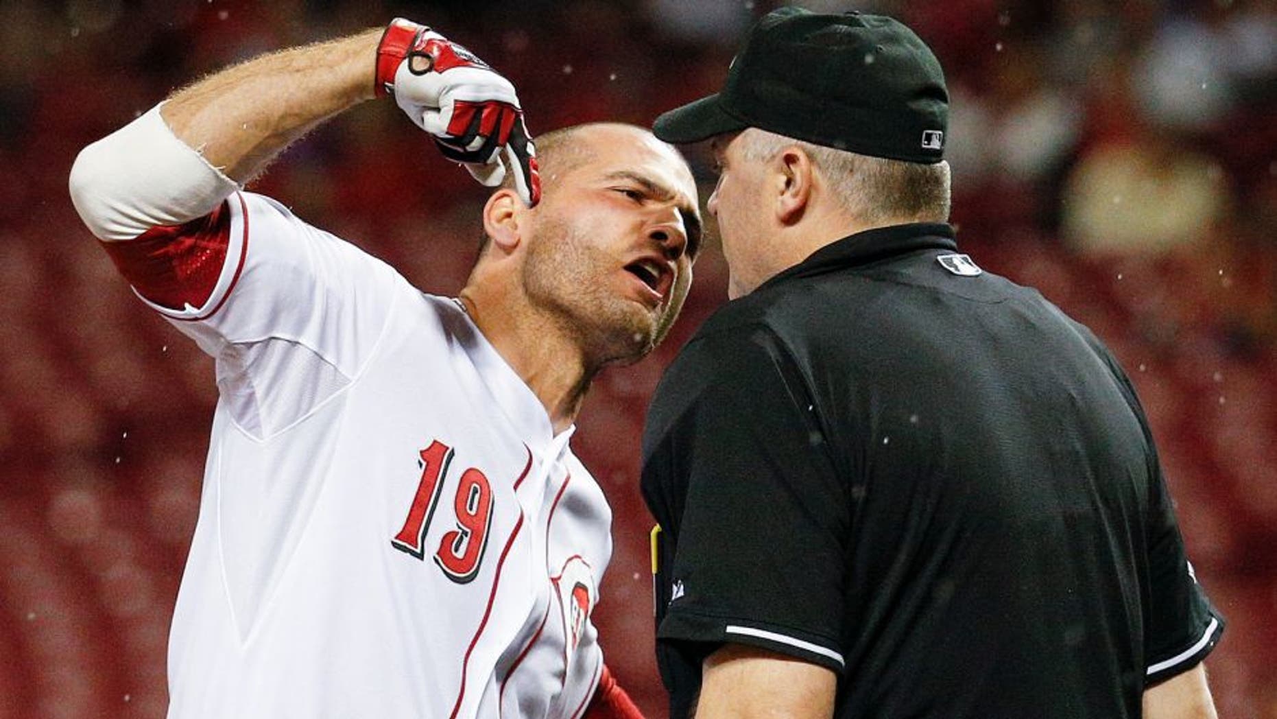Cincinnati Reds' Joey Votto (19) argues with umpire Bill Welke after being thrown out of the game for arguing balls and strikes during the eighth inning of a baseball game against the Pittsburgh Pirates, Wednesday, Sept. 9, 2015, in Cincinnati. (AP Photo/John Minchillo)