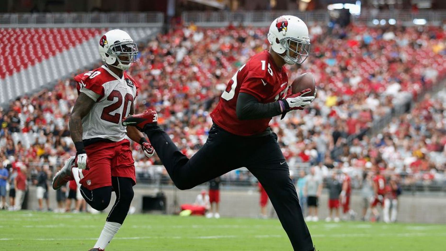 GLENDALE, AZ - AUGUST 01: Wide receiver Michael Floyd #15 of the Arizona Cardinals makes a reception past strong safety Deone Bucannon #20 during the team training camp at University of Phoenix Stadium on August 1, 2015 in Glendale, Arizona. (Photo by Christian Petersen/Getty Images)
