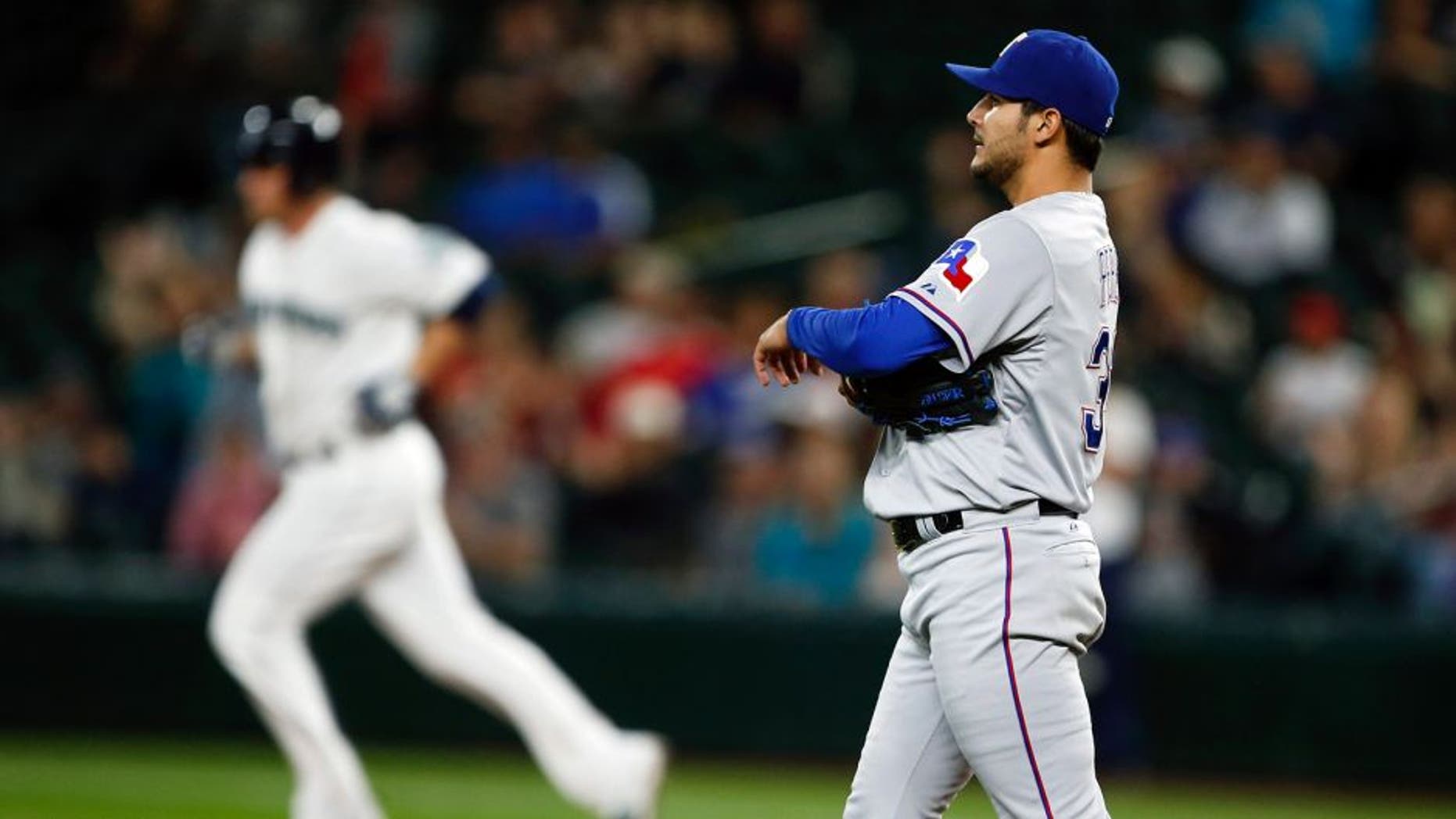 Sep 9, 2015; Seattle, WA, USA; Texas Rangers pitcher Martin Perez (33) walks around the mound after surrendering a two-run home run against the Seattle Mariners during the third inning at Safeco Field. Mandatory Credit: Joe Nicholson-USA TODAY Sports