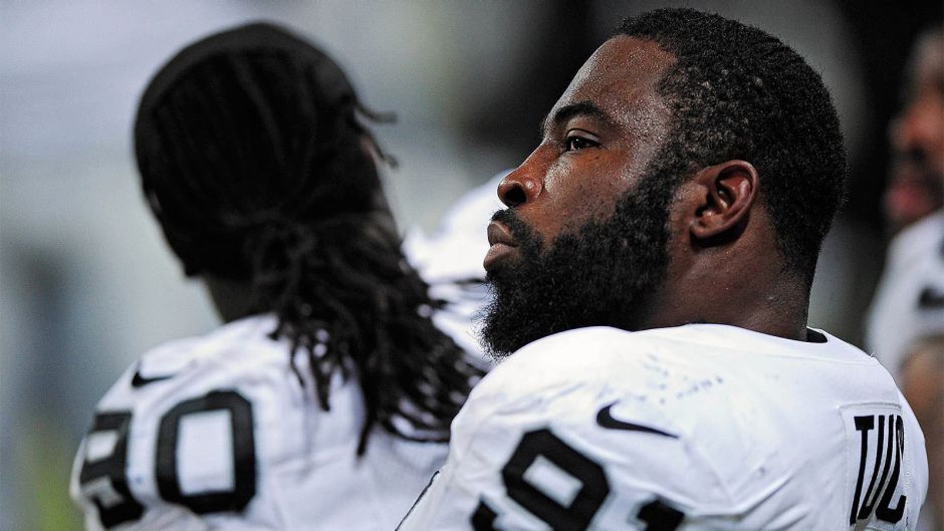 Nov 30, 2014; St. Louis, MO, USA; Oakland Raiders defensive end Justin Tuck (91) looks on from the bench during the second half against the St. Louis Rams at the Edward Jones Dome. St. Louis defeated Oakland 52-0. Mandatory Credit: Jeff Curry-USA TODAY Sports
