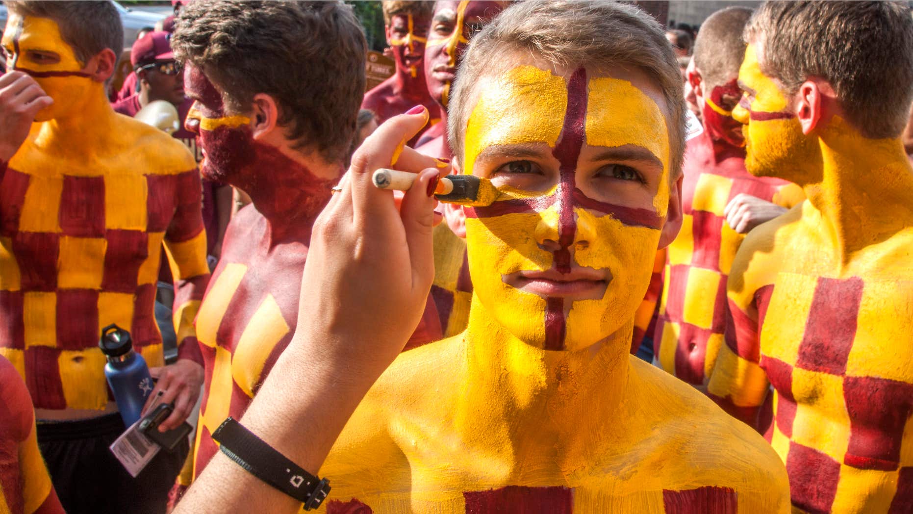 Sept. 5, 2015: Florida State fan Kyle Hill has his face painted while he waits in line for an NCAA college football game between Florida State and Texas State in Tallahassee, Fla.