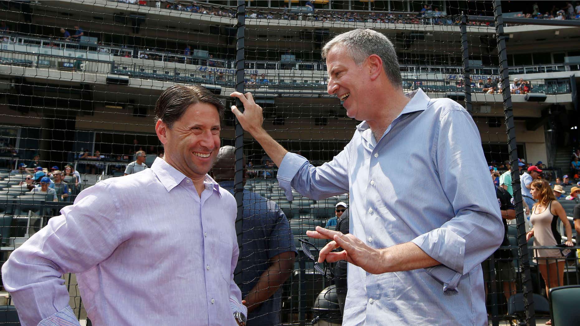 Aug. 30, 2015: New York Mayor Bill de Blasio, right, talks with New York Mets chief operating officer before an interleague baseball game between the Mets and the Boston Red Sox in New York.