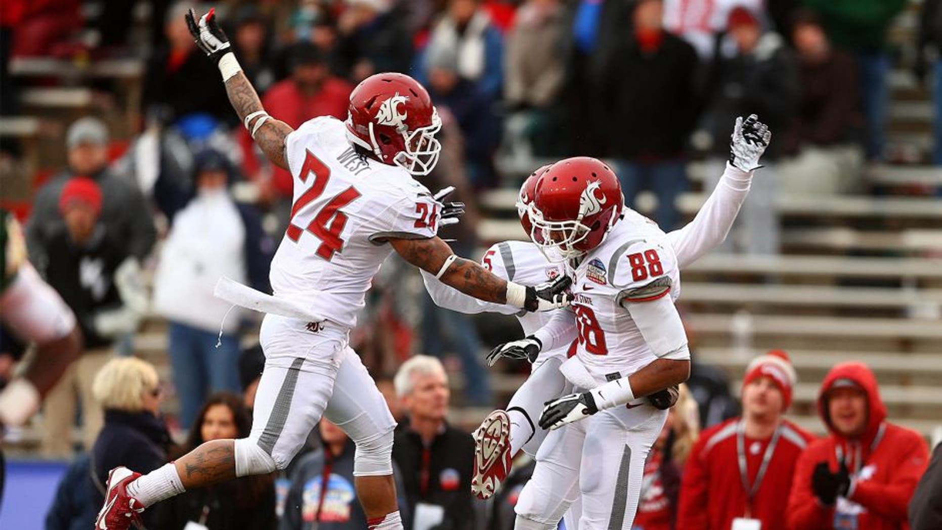 Dec 21, 2013; Albuquerque, NM, USA; Washington State Cougars wide receiver Isiah Myers (88) is congratulated by teammate Theron West (24) after a second half touchdown against the Colorado State Rams during the Gildan New Mexico Bowl at University Stadium. The Rams defeated the Cougars 48-45. Mandatory Credit: Mark J. Rebilas-USA TODAY Sports