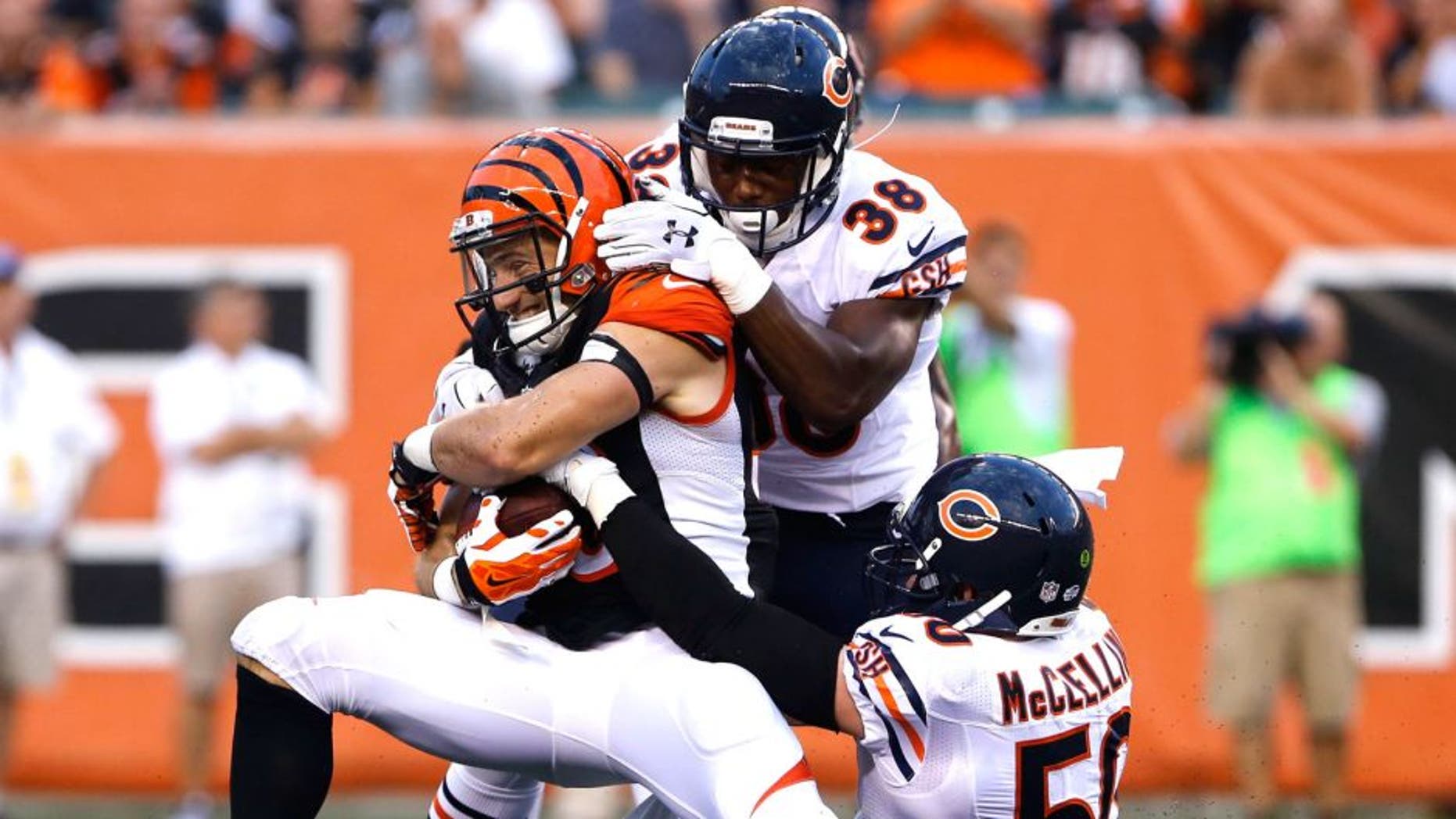 Aug 29, 2015; Cincinnati, OH, USA; Cincinnati Bengals running back Rex Burkhead (33) is tackled by Chicago Bears free safety Adrian Amos (38) and outside linebacker Shea McClellin (50) after making a catch in the first half in a preseason NFL football game at Paul Brown Stadium. Mandatory Credit: Aaron Doster-USA TODAY Sports