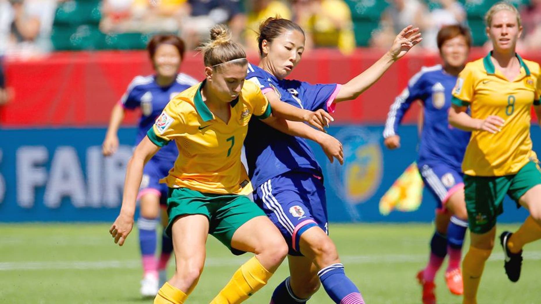 EDMONTON, AB - JUNE 27: Steph Catley #7 of Australia challenges Yuki Ogimi #17 of Japan during the FIFA Women's World Cup Canada 2015 Quarter Final match between Australia and Japan at Commonwealth Stadium on June 27, 2015 in Edmonton, Canada. (Photo by Kevin C. Cox/Getty Images)