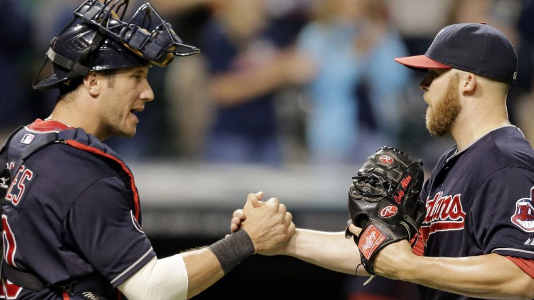 Cleveland Indians catcher Yan Gomes, left, congratulates relief pitcher Cody Allen after they defeated the Detroit Tigers 7-5 on Thursday night