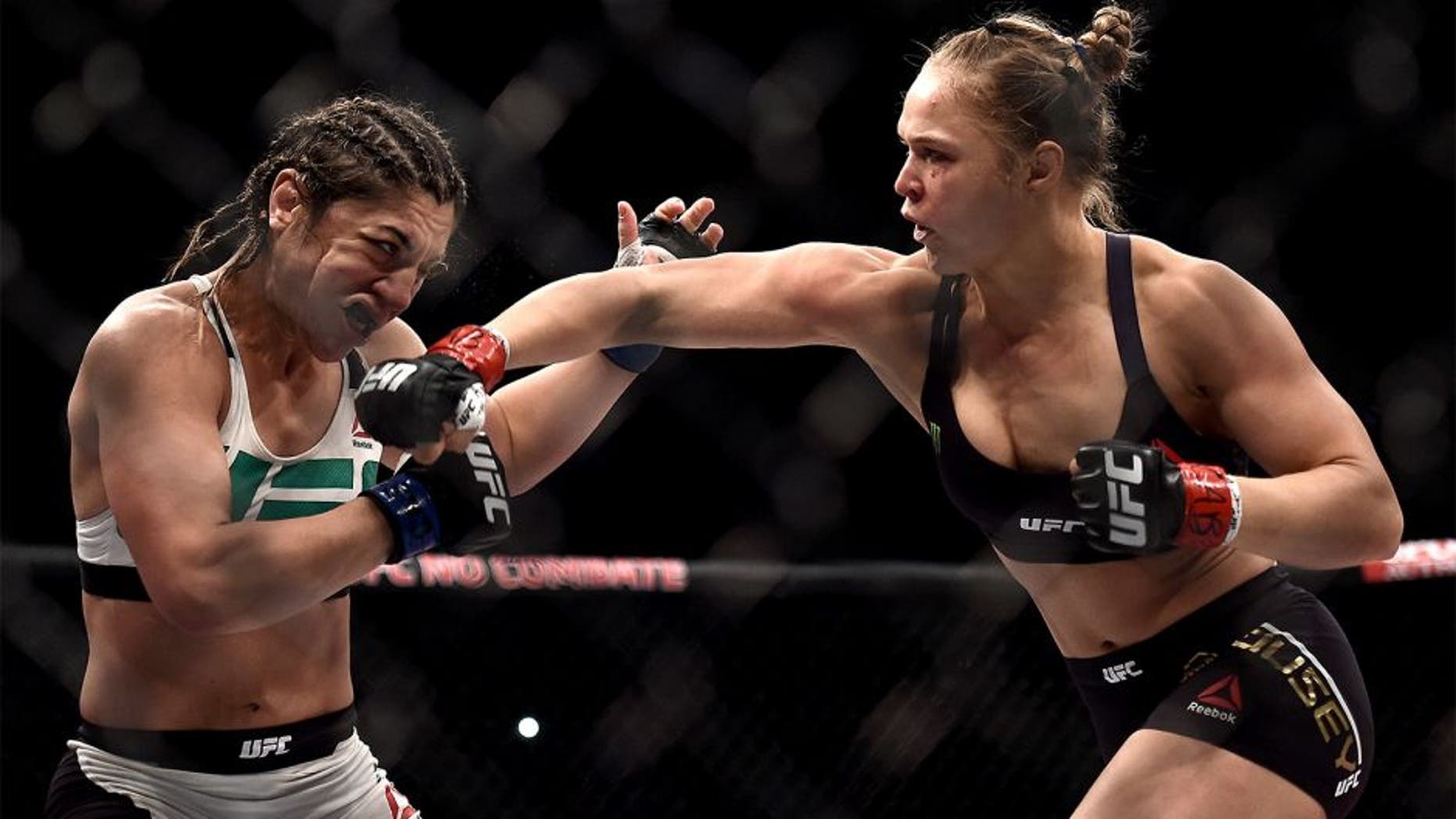 RIO DE JANEIRO, BRAZIL - AUGUST 01: Ronda Rousey of the United States punches Bethe Correia of Brazil in their bantamweight title fight during the UFC 190 Rousey v Correia at HSBC Arena on August 1, 2015 in Rio de Janeiro, Brazil. (Photo by Buda Mendes/Zuffa LLC/Zuffa LLC via Getty Images)