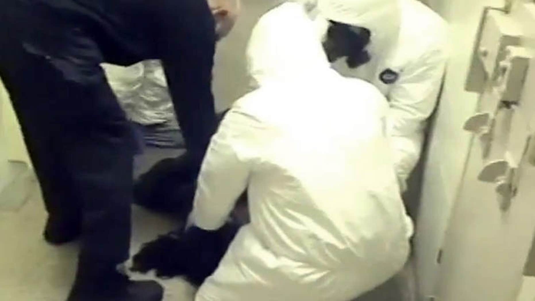 In this Feb. 3, 2015 frame from video provided by the Fairfax County, Va., Sheriff, deputies work to restrain Natasha McKenna during a cell transfer, in Fairfax, Va.