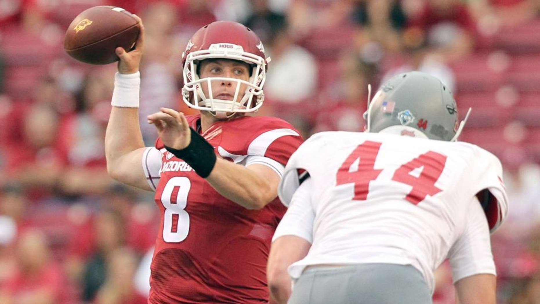Sep 6, 2014; Fayetteville, AR, USA; Arkansas Razorbacks quarterback Austin Allen (8) looks to pass defended by Nicholls State Colonels linebacker John Williamson (44) at Donald W. Reynolds Razorback Stadium. Arkansas defeated Nicholls State 73-7. Mandatory Credit: Nelson Chenault-USA TODAY Sports