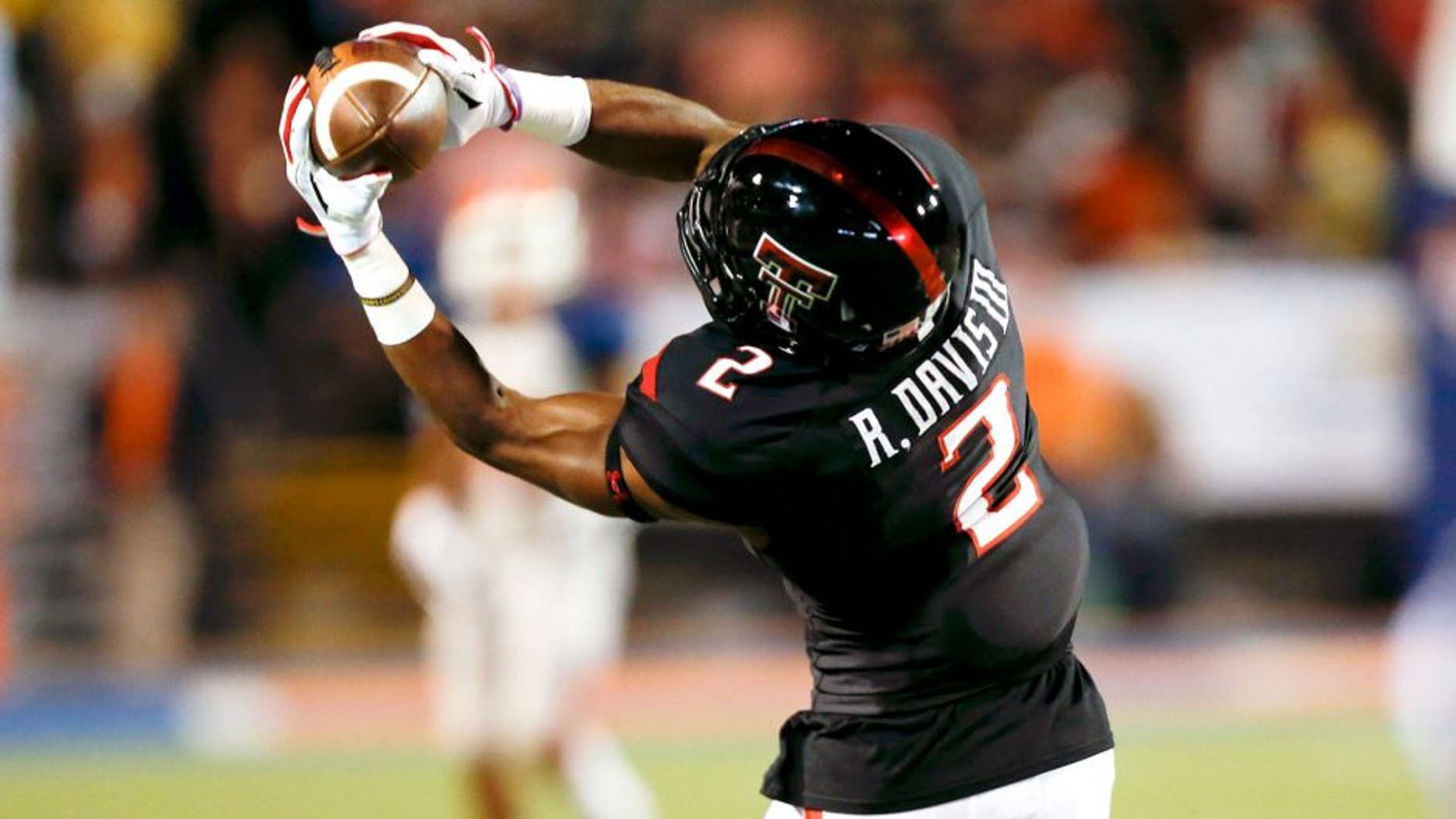 Sep 6, 2014; El Paso, TX, USA; Texas Tech Red Raiders wide receiver Reginald Davis (2) catches a ball against the UTEP Miners defense at Sun Bowl Stadium. Mandatory Credit: Ivan Pierre Aguirre-USA TODAY Sports