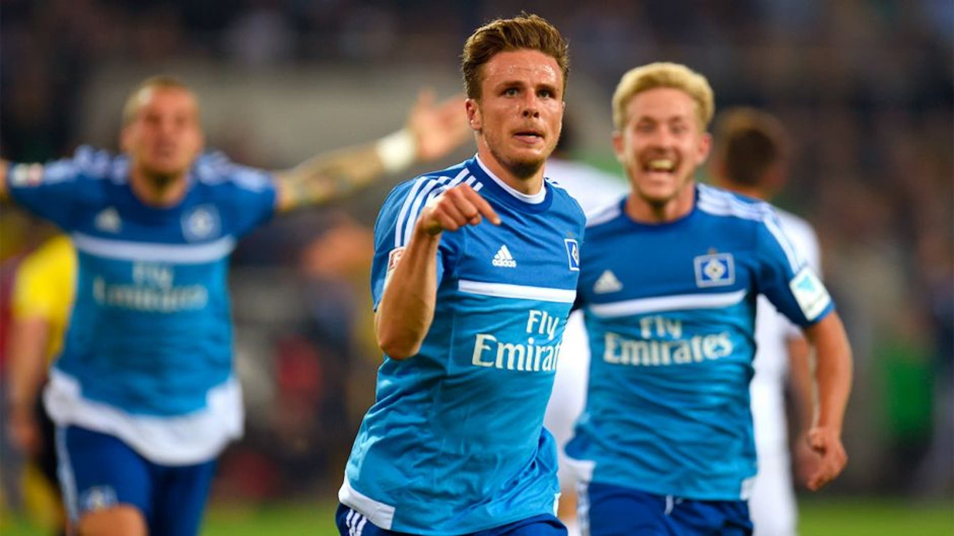 Hamburg's midfielder Nicolai Mueller celebrates after scoring during the German first division Bundesliga football match Borussia Moenchengladbach vs Hamburger SV in Moenchengladbach, western Germany, on September 11, 2015. AFP PHOTO / PATRIK STOLLARZ RESTRICTIONS: DURING MATCH TIME: DFL RULES TO LIMIT THE ONLINE USAGE TO 15 PICTURES PER MATCH AND FORBID IMAGE SEQUENCES TO SIMULATE VIDEO. == RESTRICTED TO EDITORIAL USE == FOR FURTHER QUERIES PLEASE CONTACT DFL DIRECTLY AT + 49 69 650050. (Photo credit should read PATRIK STOLLARZ/AFP/Getty Images)
