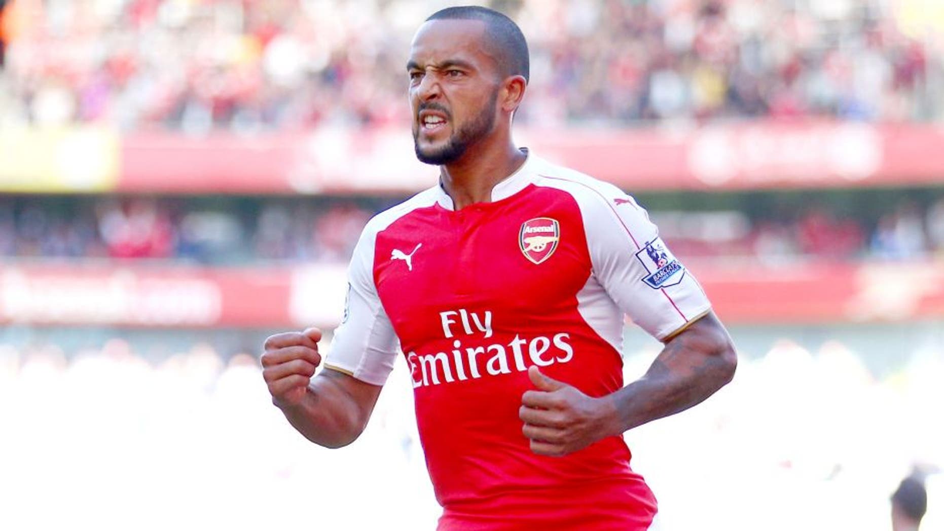 LONDON, ENGLAND - SEPTEMBER 12: Theo Walcott of Arsenal celebrates scoring the opening goal during the Barclays Premier League match between Arsenal and Stoke City at the Emirates Stadium on September 12, 2015 in London, United Kingdom. (Photo by Paul Gilham/Getty Images)