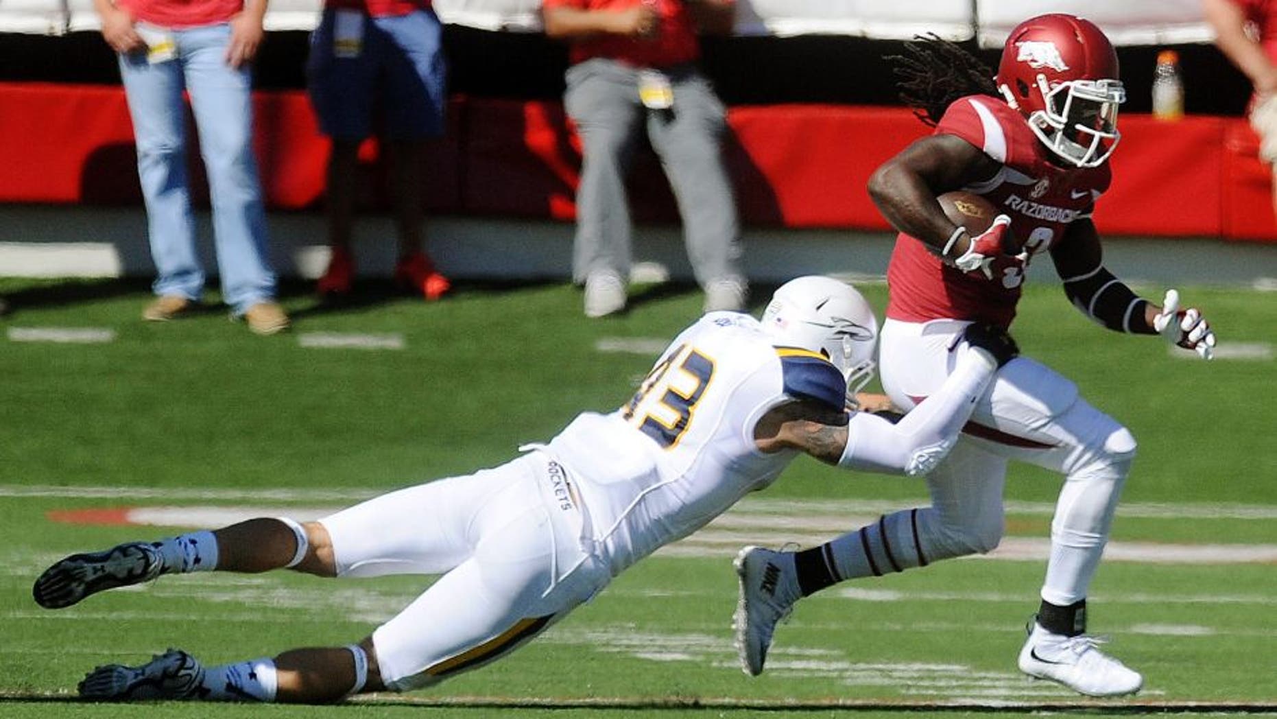 Sep 12, 2015; Fayetteville, AR, USA; Arkansas Razorbacks running back Alex Collins (3) runs the ball against Toledo Rockets defensive end Trent Voss (43) during the first quarter at War Memorial Stadium. Mandatory Credit: Mark D. Smith-USA TODAY Sports