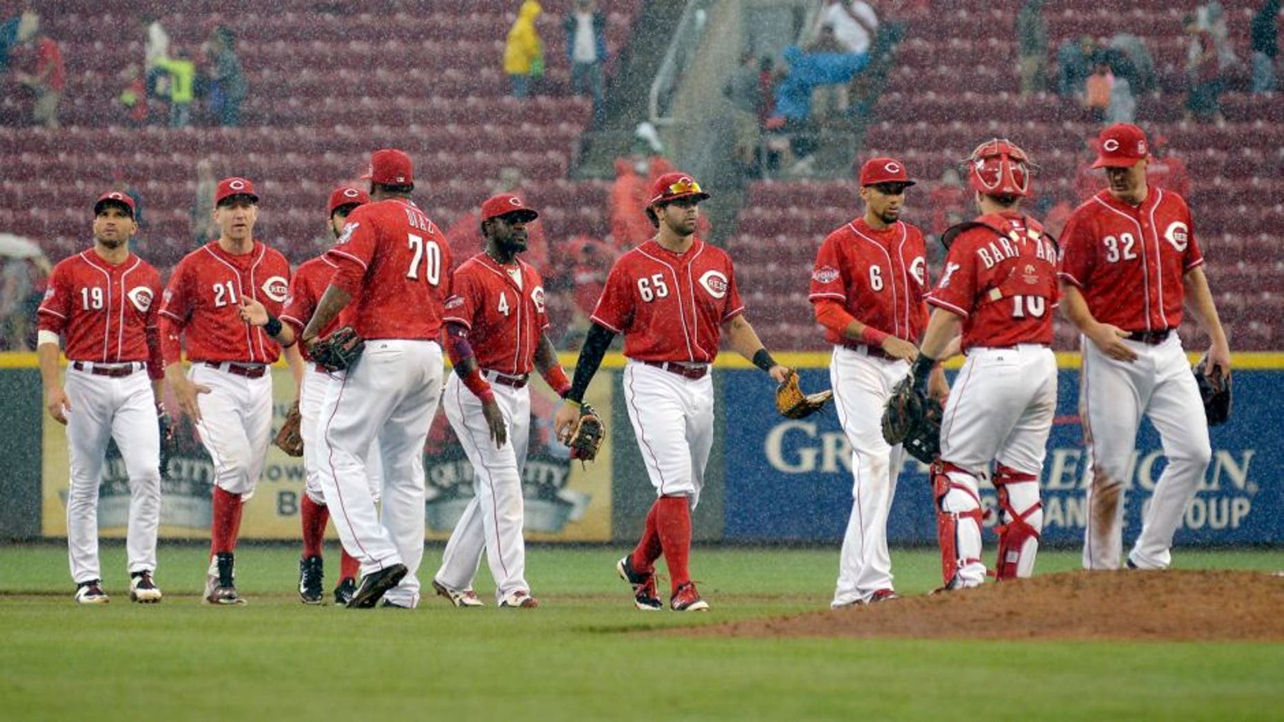 CINCINNATI, OH - SEPTEMBER 12: The Cincinnati Reds celebrate after beating the St. Louis Cardinals 5-1 at Great American Ball Park on September 12, 2015 in Cincinnati, Ohio. (Photo by Dylan Buell/Getty Images)
