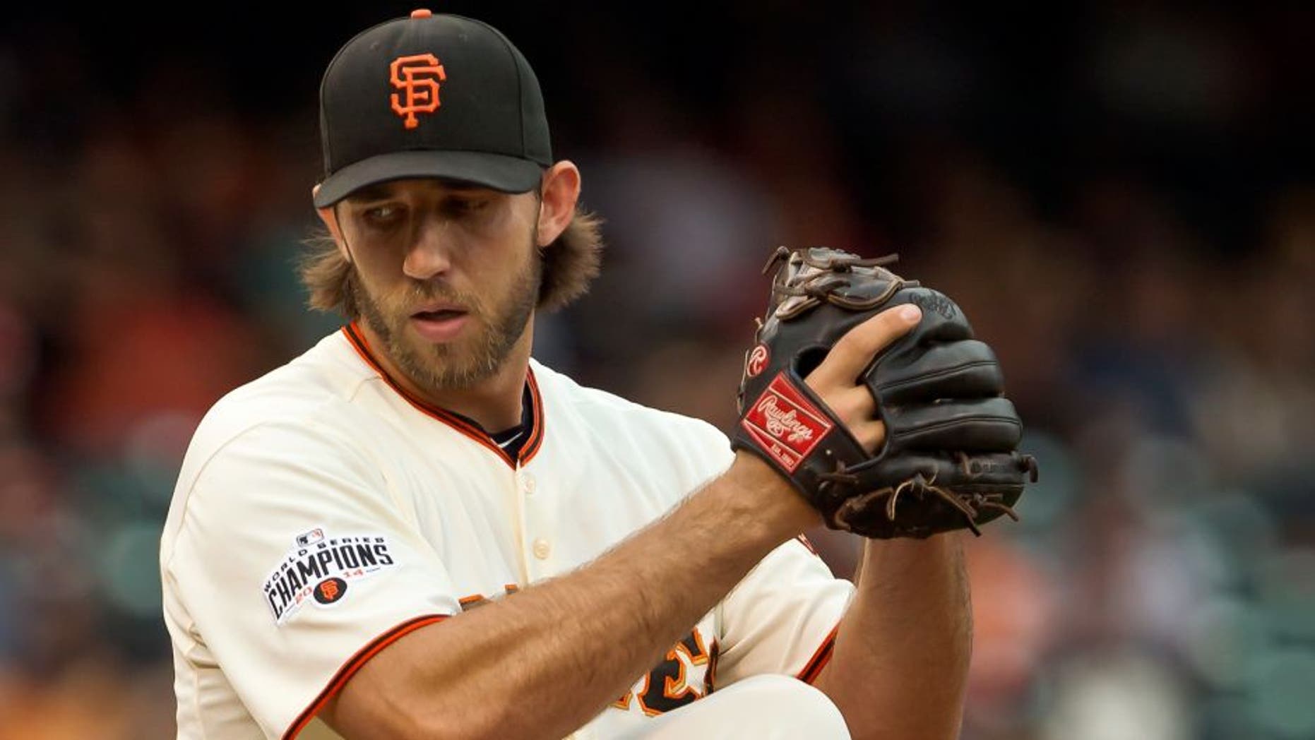 SAN FRANCISCO, CA - SEPTEMBER 12: Starting pitcher Madison Bumgarner #40 of the San Francisco Giants winds up for a pitch against the San Dieigo Padres at AT&T Park in the first inning on September 12, 2015 in San Francisco, California. (Photo by Brian Bahr/Getty Images)