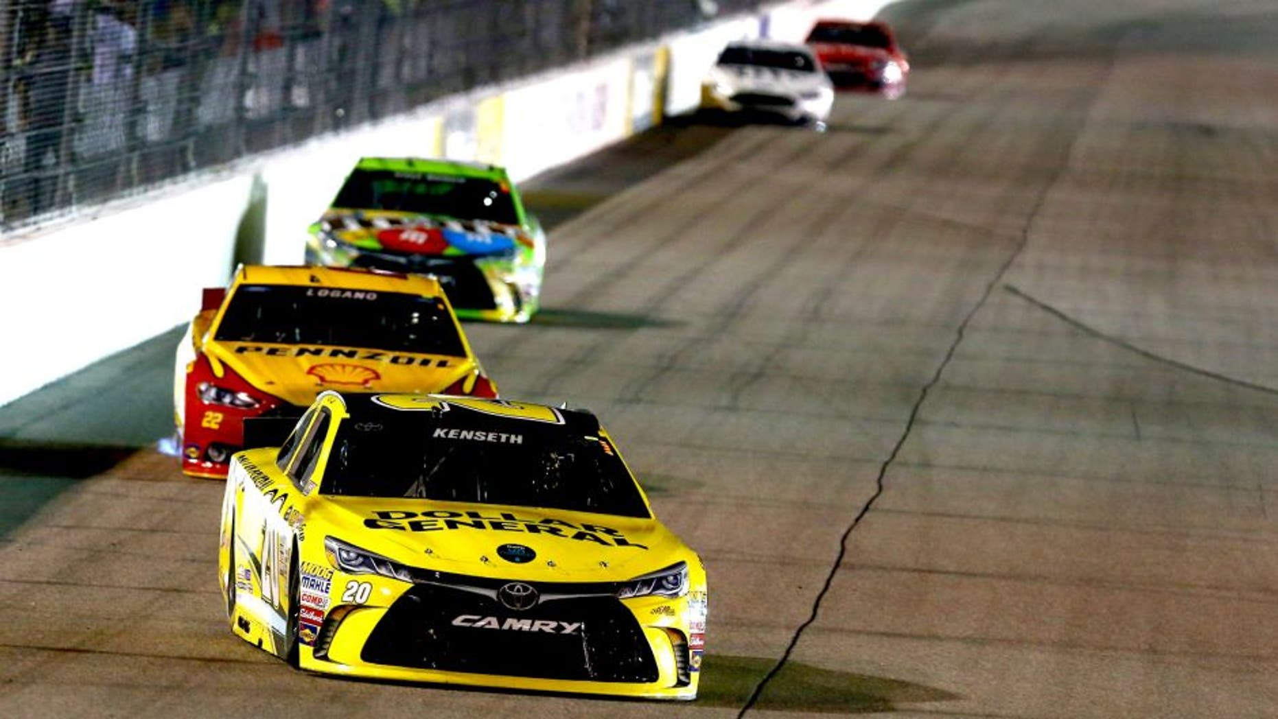RICHMOND, VA - SEPTEMBER 12: Matt Kenseth, driver of the #20 Dollar General Toyota, leads a pack of cars during the NASCAR Sprint Cup Series Federated Auto Parts 400 at Richmond International Raceway on September 12, 2015 in Richmond, Virginia. (Photo by Sarah Crabill/Getty Images)