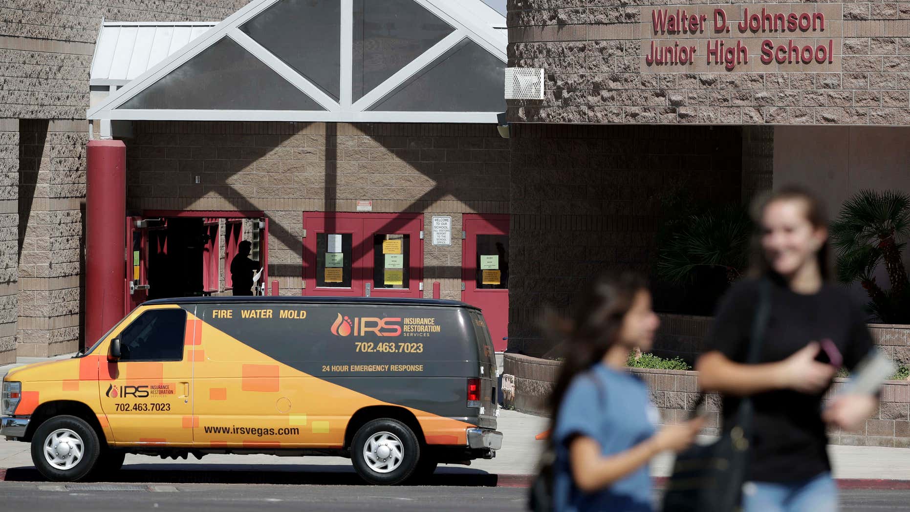 People walk by Walter Johnson Junior High School, Monday, Sept. 12, 2016, in Las Vegas.