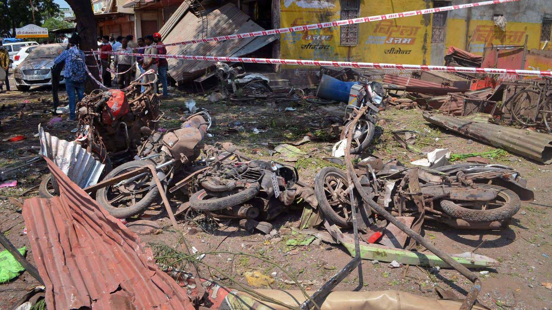 Sept. 12, 2015: A crowd gathers at the site of an explosion near damaged motorbikes in Petlawad district, in the central Indian state of Madhya Pradesh.