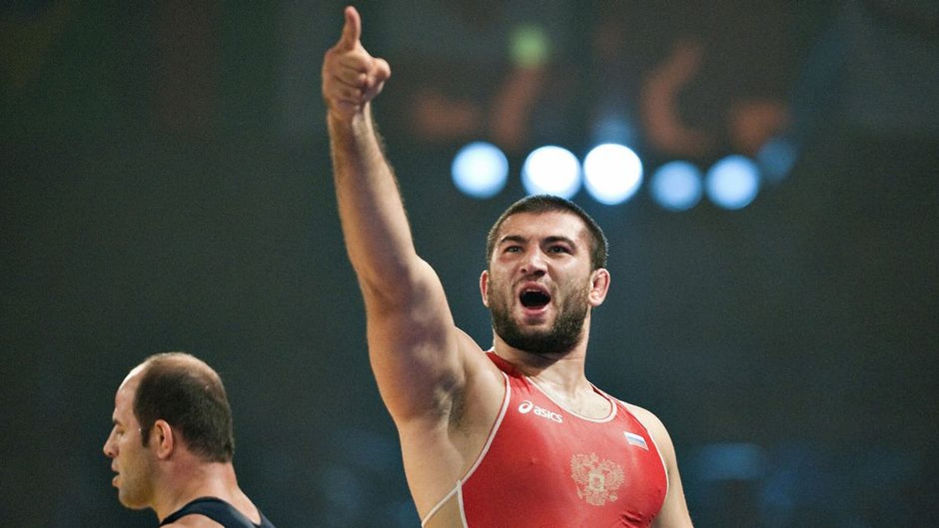 Biyal Makhov of Russia (R) celebrates his victory over Valadi Masoumi of Iran (L) in the 120 kilo freestyle final on September 22, 2009 in the World Wrestling Championships in Herning, western Denmark. AFP PHOTO Henning Bagger/SCANPIX DANMARK (Photo credit should read HENNING BAGGER/AFP/Getty Images)