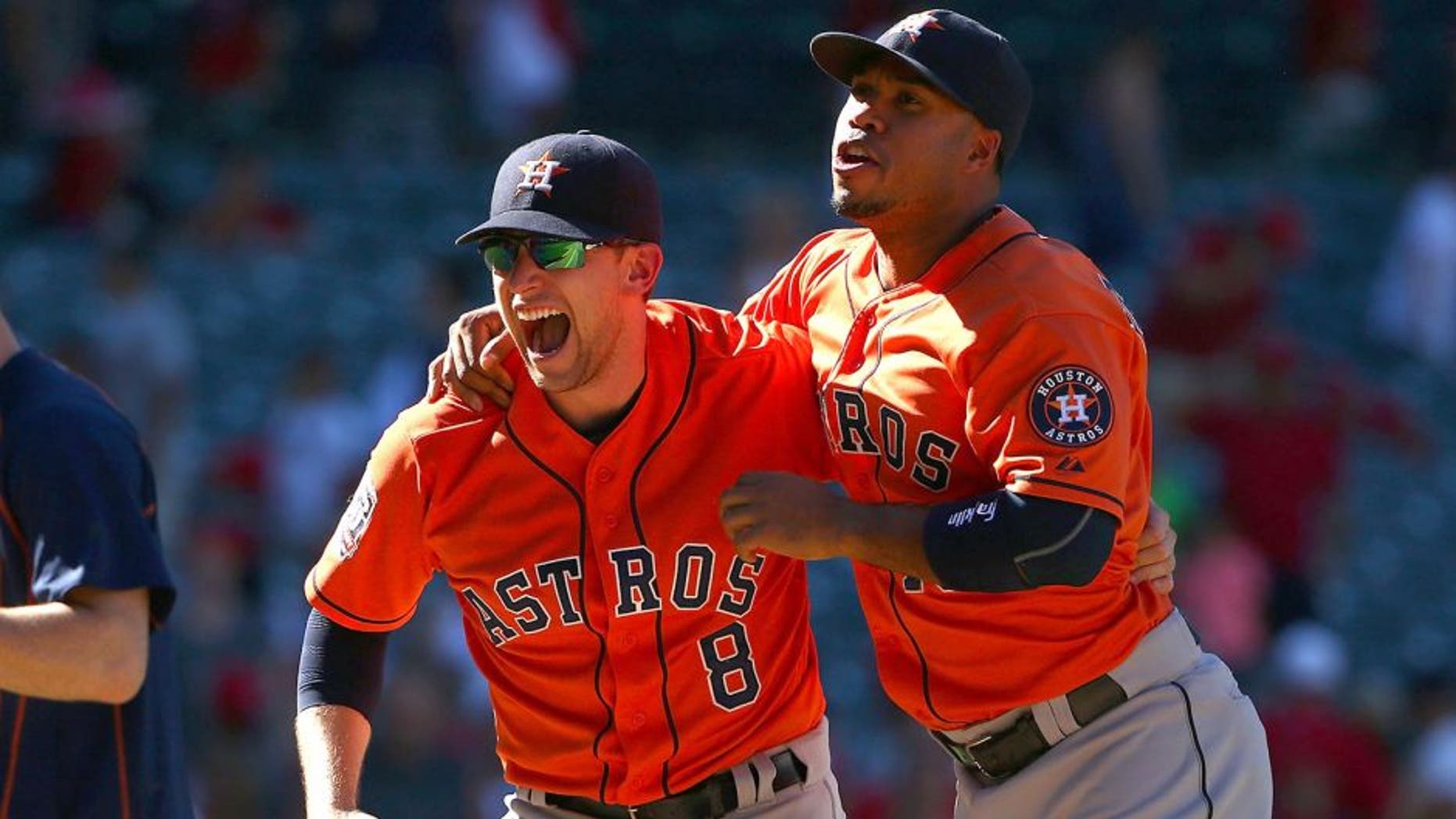 ANAHEIM, CA - SEPTEMBER 13: Jed Lowrie #8 and Luis Valbuena #18 of the Houston Astros celebrate after their 5-3 come-from-behind win against the Los Angeles Angels of Anaheim in the ninth inning in their MLB game at Angel Stadium of Anaheim on September 13, 2015 in Anaheim, California. (Photo by Victor Decolongon/Getty Images)