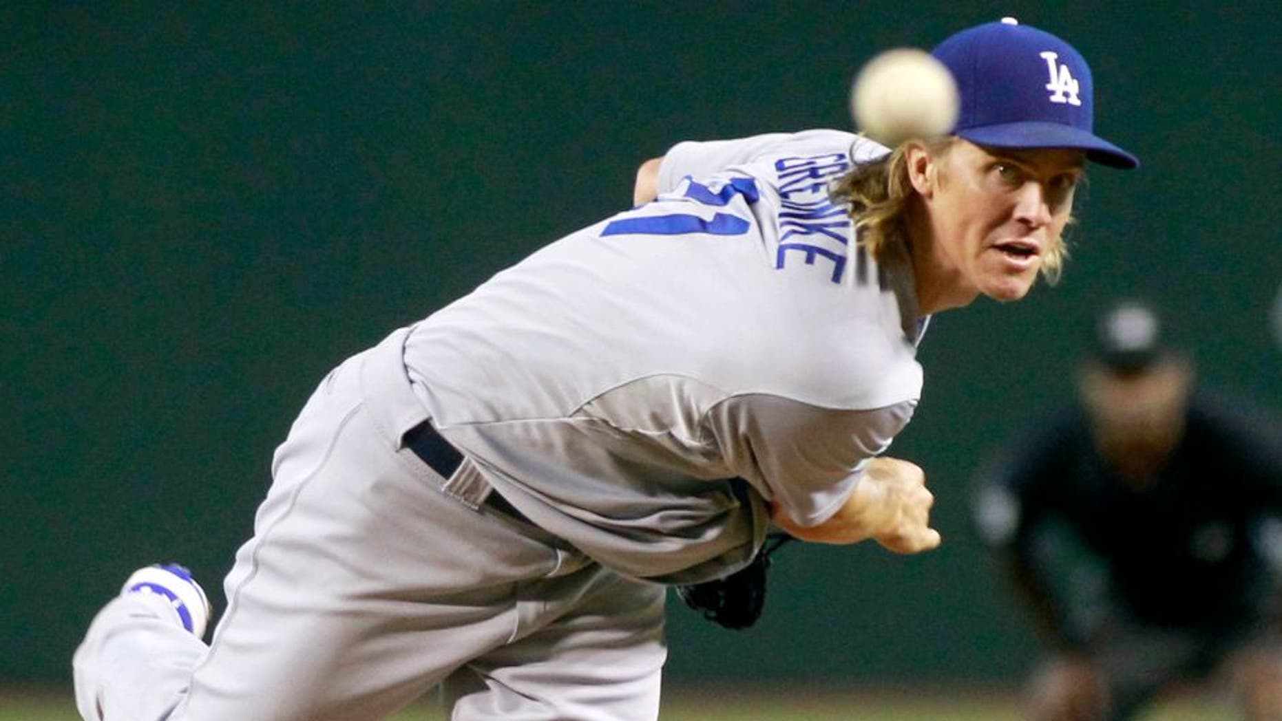 Los Angeles Dodgers starting pitcher Zach Greinke throws against the Arizona Diamondbacks during the first inning of a baseball game, Sunday, Sept. 13, 2015, in Phoenix. (AP Photo/Ralph Freso)