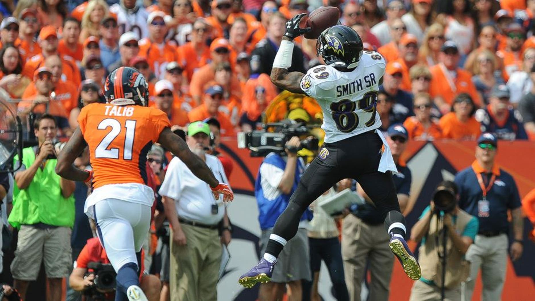 DENVER, CO - SEPTEMBER 13: Wide receiver Steve Smith #89 of the Baltimore Ravens has a first quarter reception under coverage by cornerback Aqib Talib #21 of the Denver Broncos during a game at Sports Authority Field at Mile High on September 13, 2015 in Denver, Colorado. (Photo by Dustin Bradford/Getty Images)