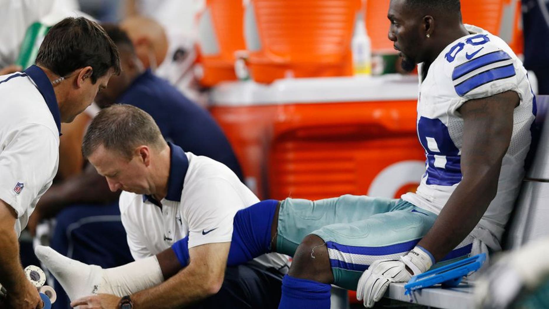 Sep 13, 2015; Arlington, TX, USA; Dallas Cowboys receiver Dez Bryant (88) gets his right ankle worked on by trainers while on the bench in the fourth quarter against the New York Giants at AT&T Stadium. Mandatory Credit: Matthew Emmons-USA TODAY Sports