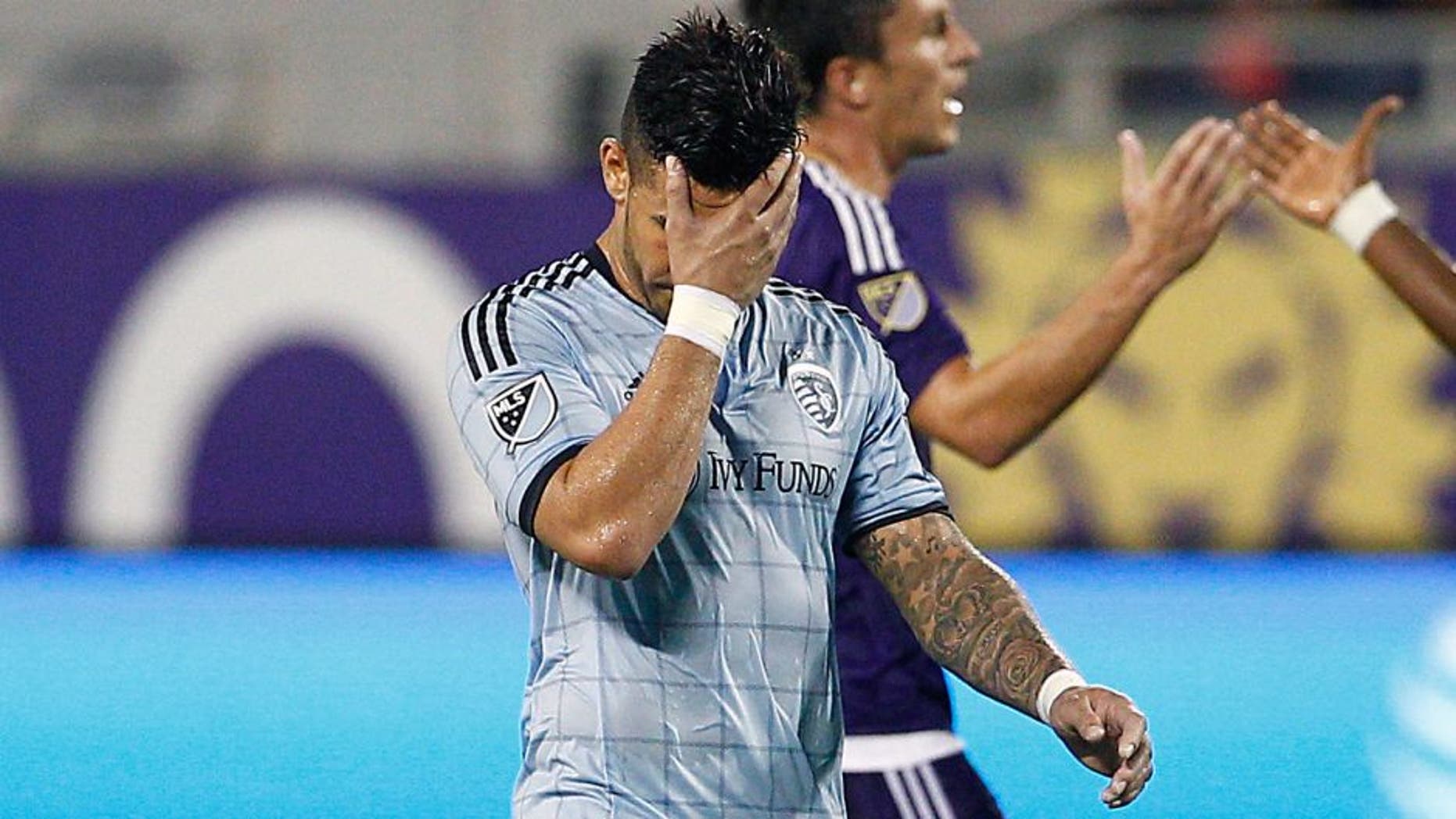 Sep 13, 2015; Orlando, FL, USA; Sporting KC forward Dom Dwyer (14) covers his face after being issued a red card during the second half against the Orlando City FC at Orlando Citrus Bowl Stadium. Mandatory Credit: Reinhold Matay-USA TODAY Sports