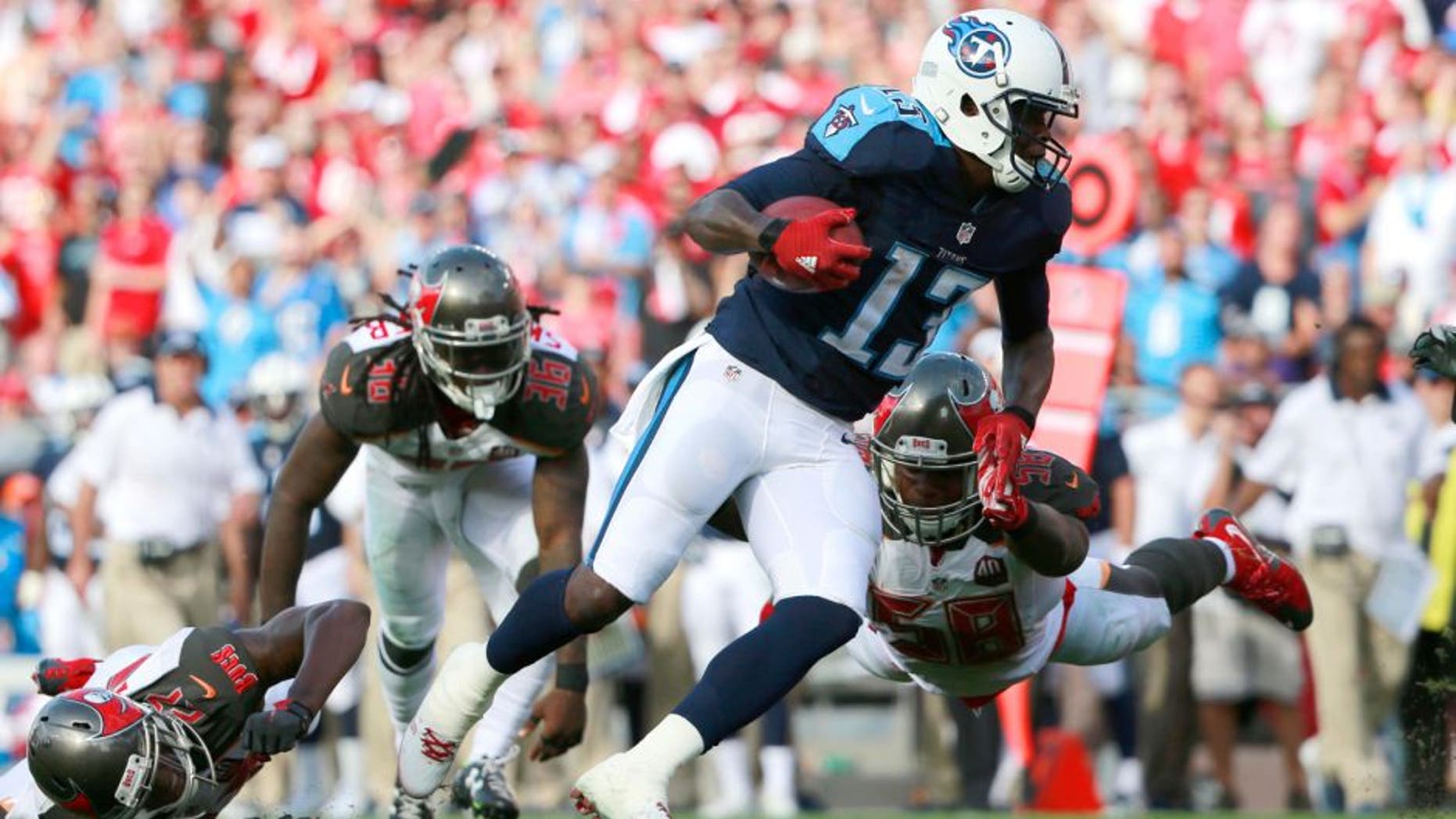 Sep 13, 2015; Tampa, FL, USA; Tennessee Titans wide receiver Kendall Wright (13) runs past Tampa Bay Buccaneers outside linebacker Kwon Alexander (58) during the first half at Raymond James Stadium. Mandatory Credit: Kim Klement-USA TODAY Sports