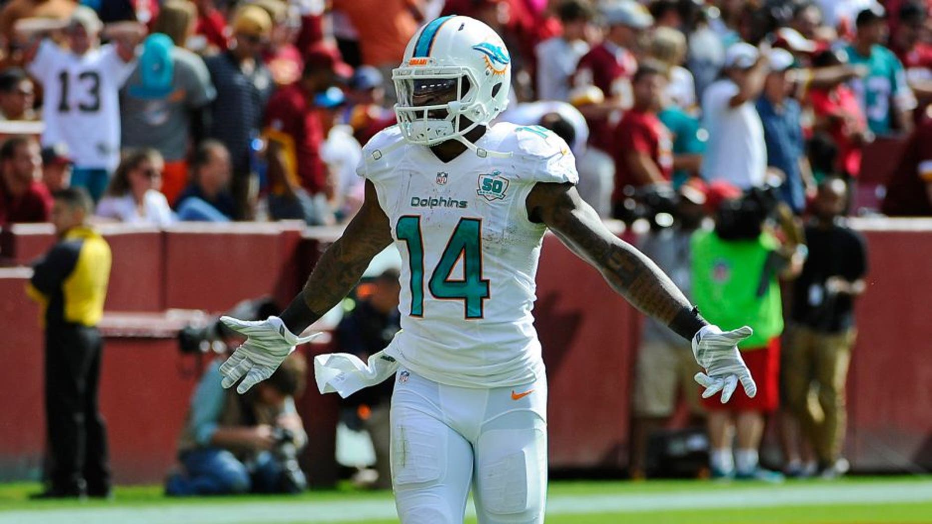 Sep 13, 2015; Landover, MD, USA; Miami Dolphins wide receiver Jarvis Landry (14) celebrates after scoring a touchdown against the Washington Redskins during the second half at FedEx Field. Mandatory Credit: Brad Mills-USA TODAY Sports