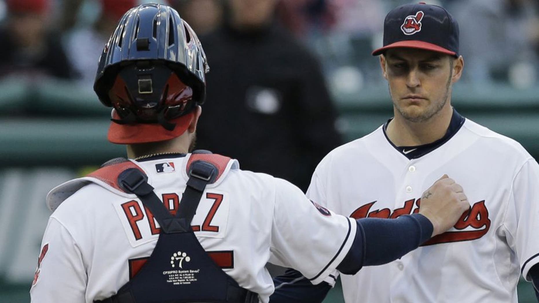 Cleveland Indians catcher Roberto Perez, left, talks with starting pitcher Trevor Bauer in the fourth inning of the second game of a baseball doubleheader against the Detroit Tigers
