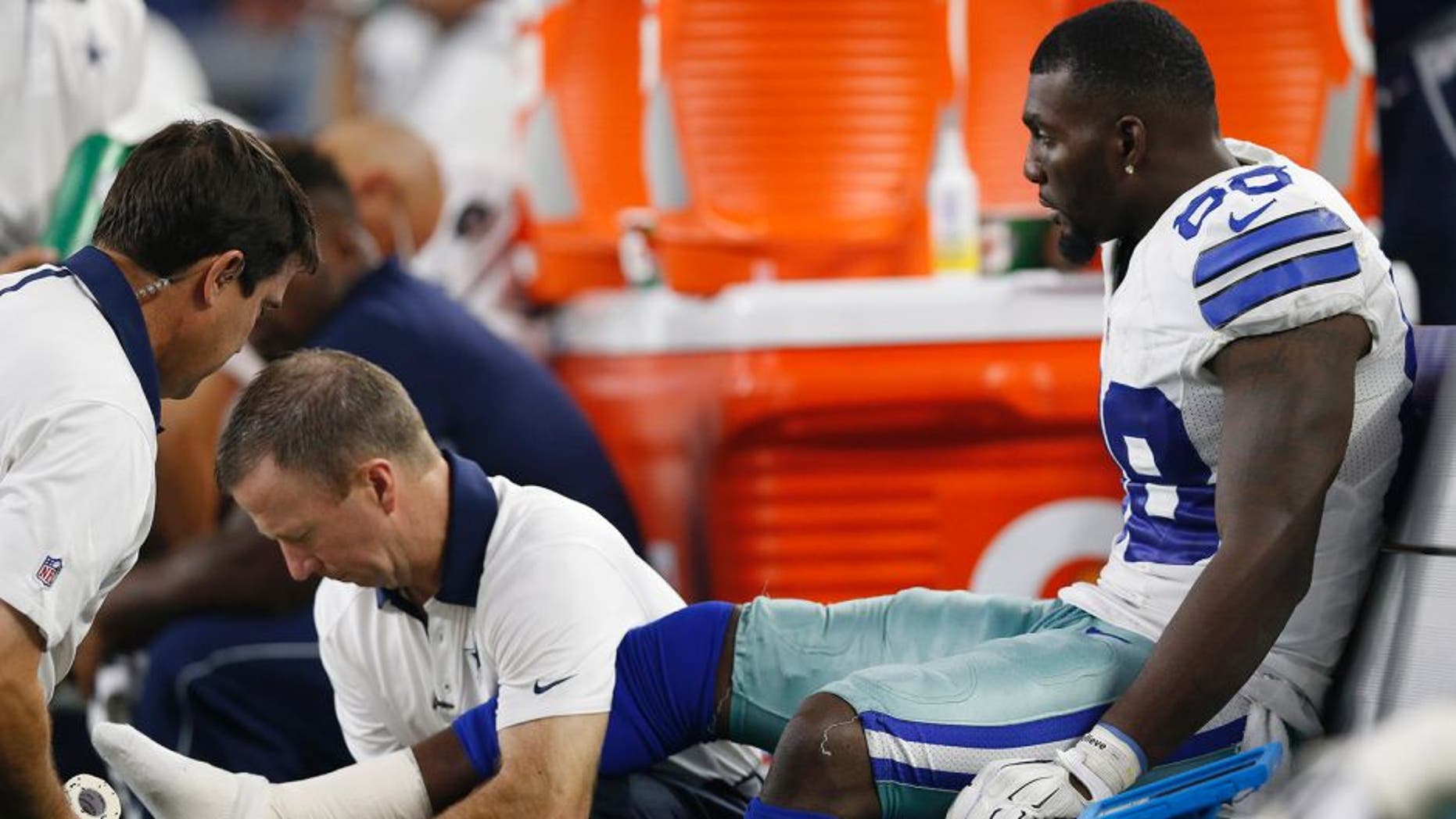 Sep 13, 2015; Arlington, TX, USA; Dallas Cowboys receiver Dez Bryant (88) gets his right ankle worked on by trainers while on the bench in the fourth quarter against the New York Giants at AT&T Stadium. Mandatory Credit: Matthew Emmons-USA TODAY Sports