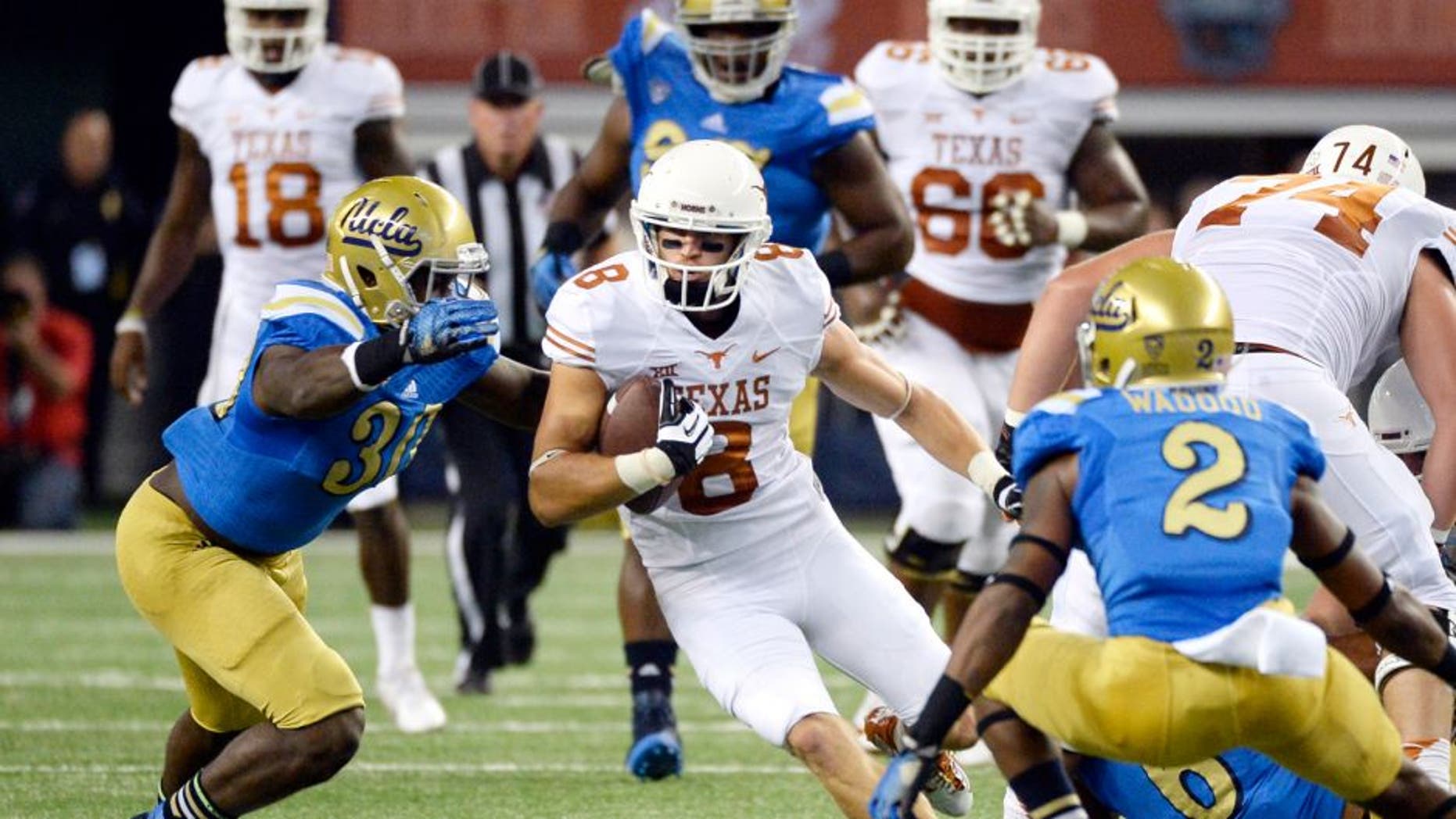 Sep 13, 2014; Arlington, TX, USA; Texas Longhorns wide receiver Jaxon Shipley (8) runs against UCLA Bruins linebacker Myles Jack (30) and defensive back Jaleel Wadood (2)during the first quarter at AT&T Stadium. Mandatory Credit: Richard Mackson-USA TODAY Sports