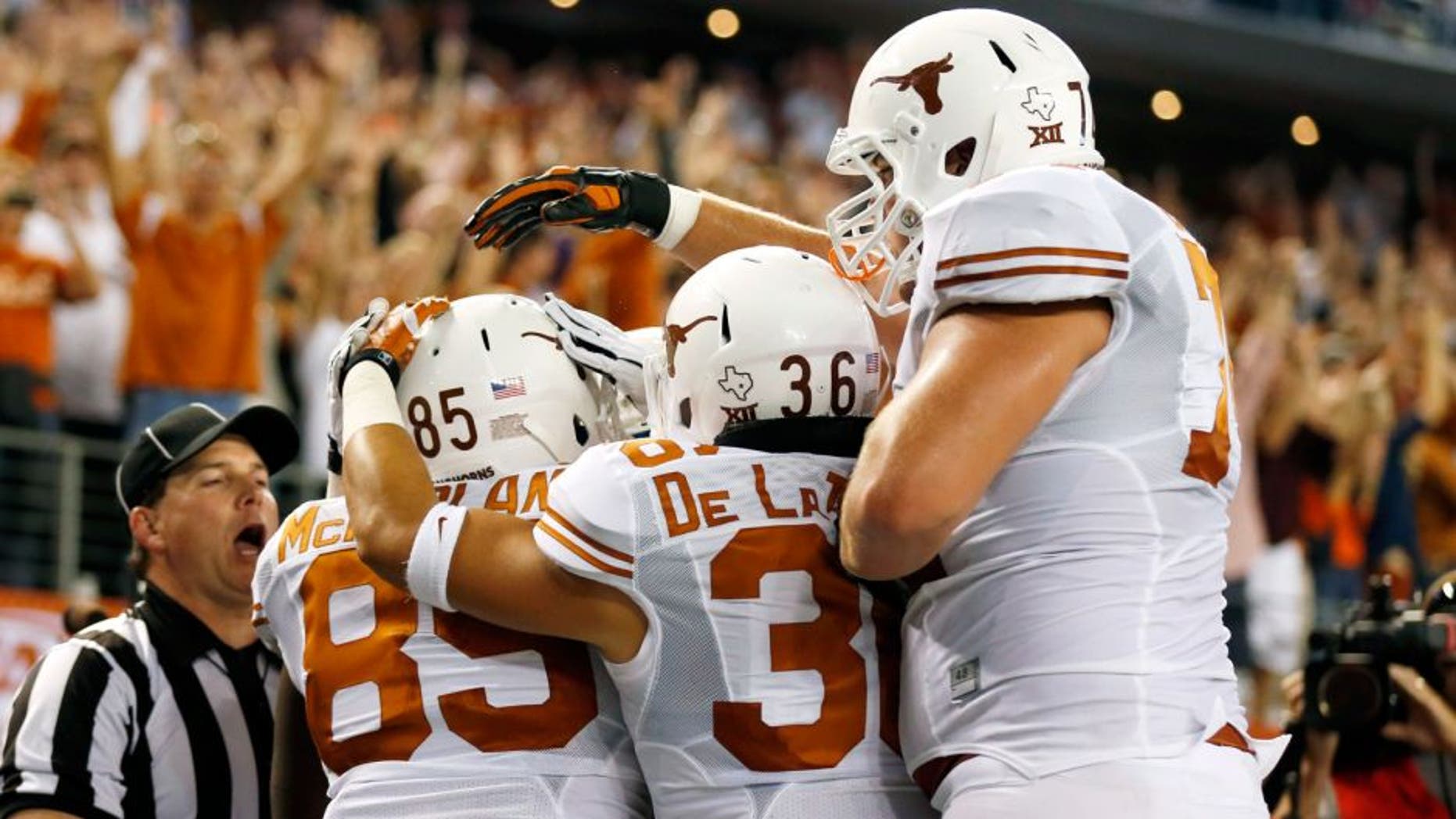 Sep 13, 2014; Arlington, TX, USA; Texas Longhorns tight end M.J. McFarland (85) celebrates making a touchdown with fullback Alex De La Torre (36) against the UCLA Bruins during the second quarter at AT&T Stadium. Mandatory Credit: Matthew Emmons-USA TODAY Sports