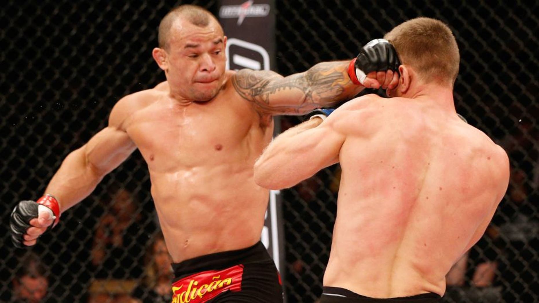 BRASILIA, BRAZIL - SEPTEMBER 13: (L-R) Gleison Tibau of Brazil lands a spinning back fist against Piotr Hallmann of Poland in their lightweight bout during the UFC Fight Night event inside Nilson Nelson Gymnasium on September 13, 2014 in Brasilia, Brazil. (Photo by Josh Hedges/Zuffa LLC/Zuffa LLC via Getty Images)