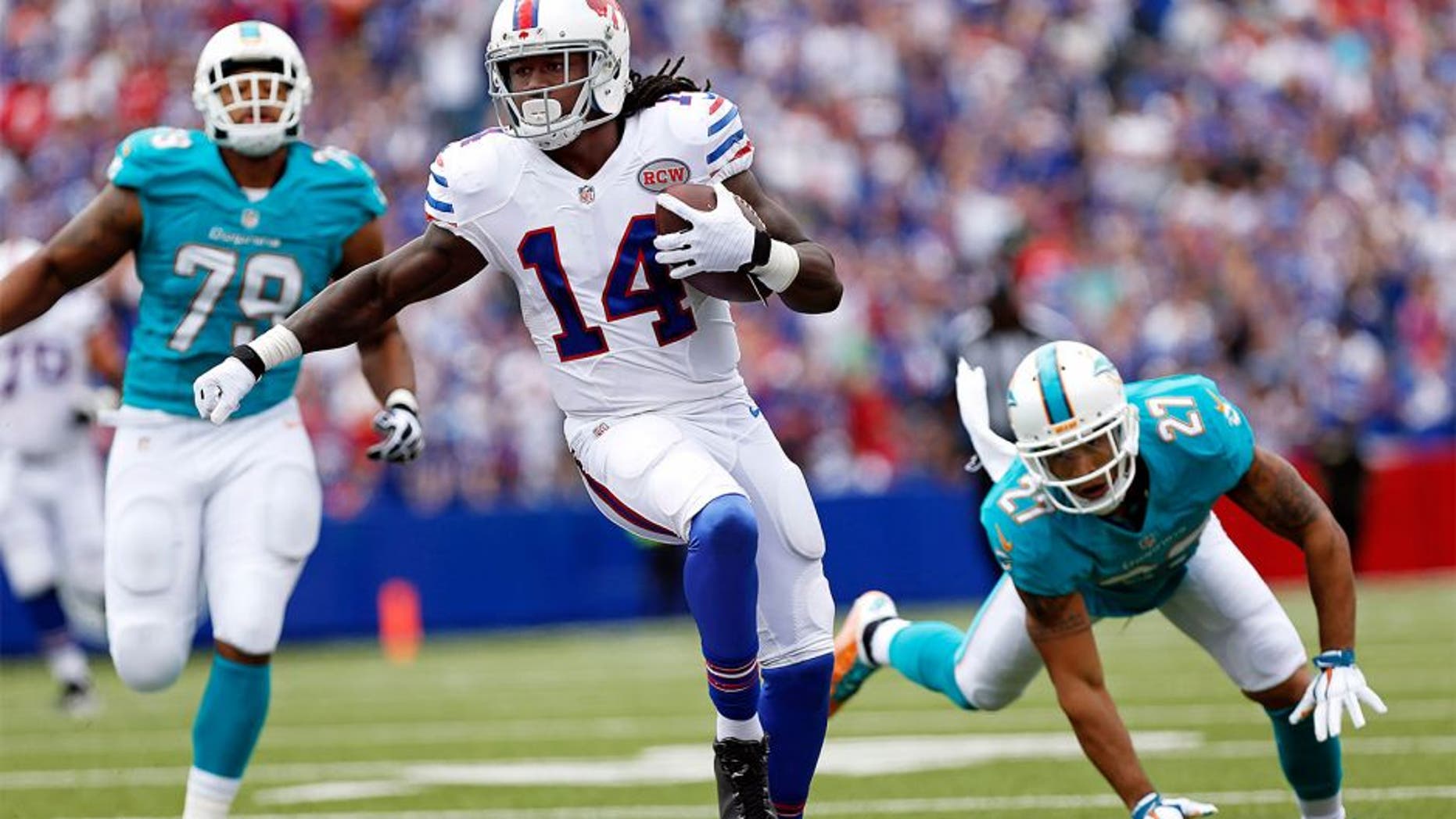 Sep 14, 2014; Orchard Park, NY, USA; Buffalo Bills wide receiver Sammy Watkins (14) runs after a catch as Miami Dolphins strong safety Jimmy Wilson (27) pursues during the first half at Ralph Wilson Stadium. Mandatory Credit: Kevin Hoffman-USA TODAY Sports