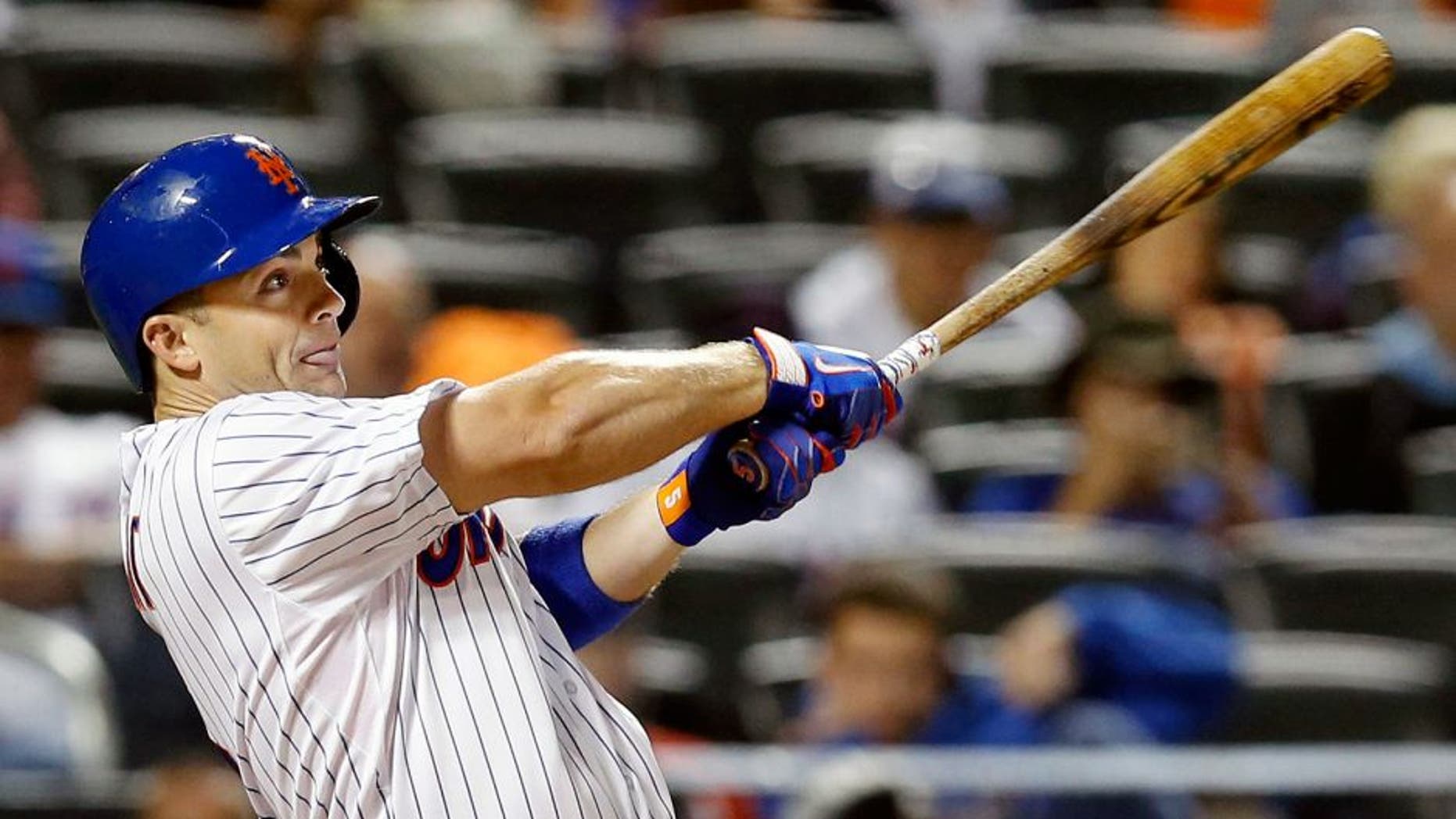 New York Mets' David Wright hits a seventh-inning, RBI, ground-rule double in a baseball game against the Miami Marlins in New York, Monday, Sept. 14, 2015. (AP Photo/Kathy Willens)