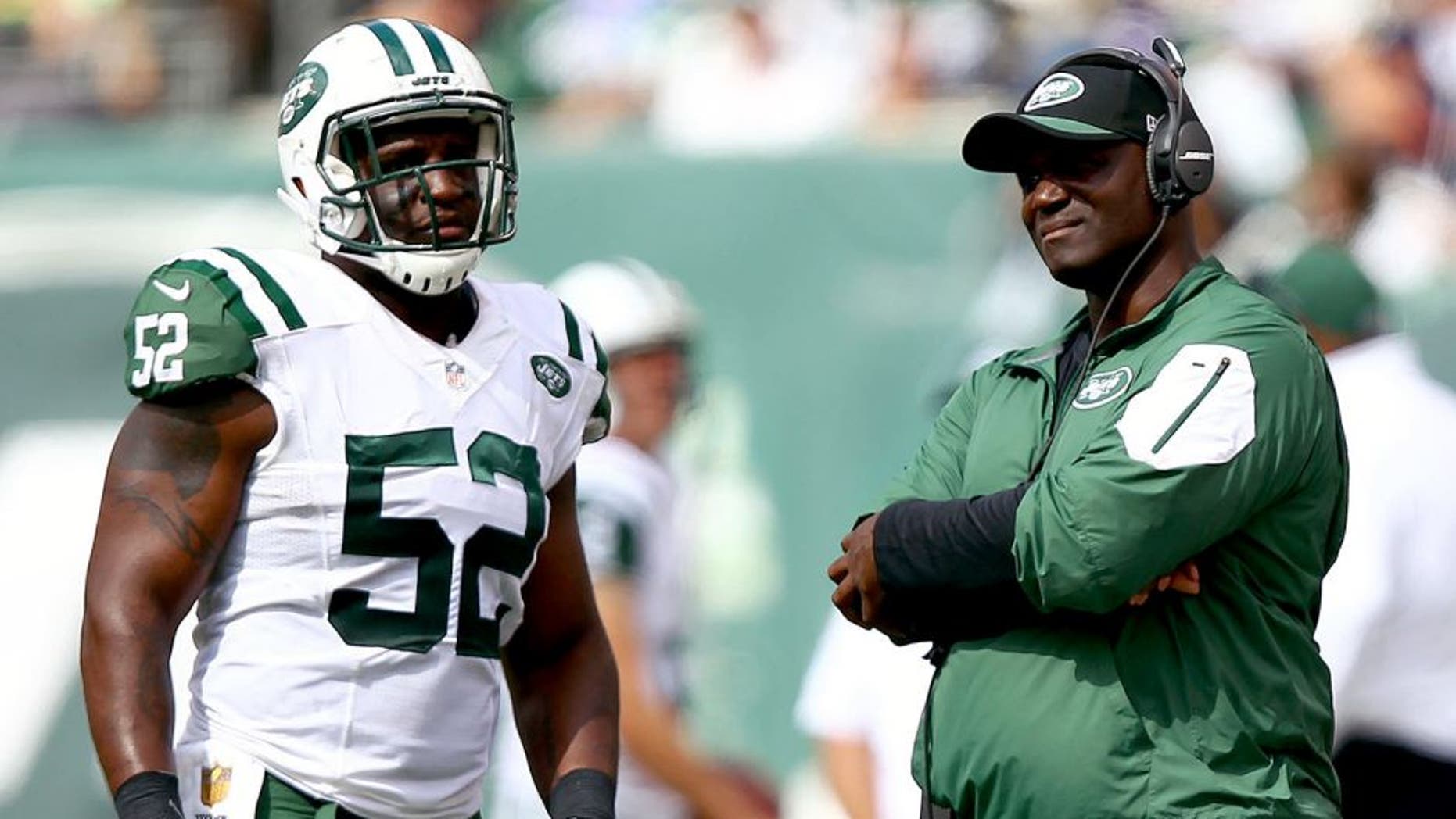 Sep 13, 2015; East Rutherford, NJ, USA; New York Jets head coach Todd Bowles talks to New York Jets linebacker David Harris (52) during the first half at MetLife Stadium. Mandatory Credit: Danny Wild-USA TODAY Sports