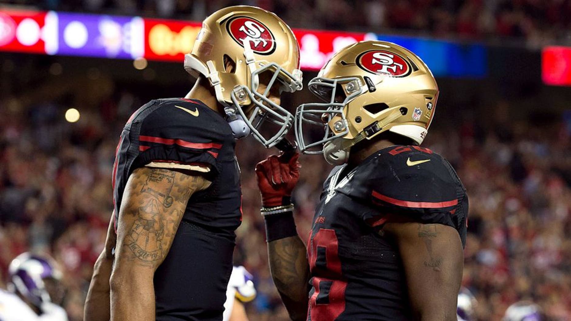 Sep 14, 2015; Santa Clara, CA, USA; San Francisco 49ers running back Carlos Hyde (28) celebrates with quarterback Colin Kaepernick (7) after scoring a touchdown against the Minnesota Vikings during the second quarter at Levi's Stadium. Mandatory Credit: Kelley L Cox-USA TODAY Sports