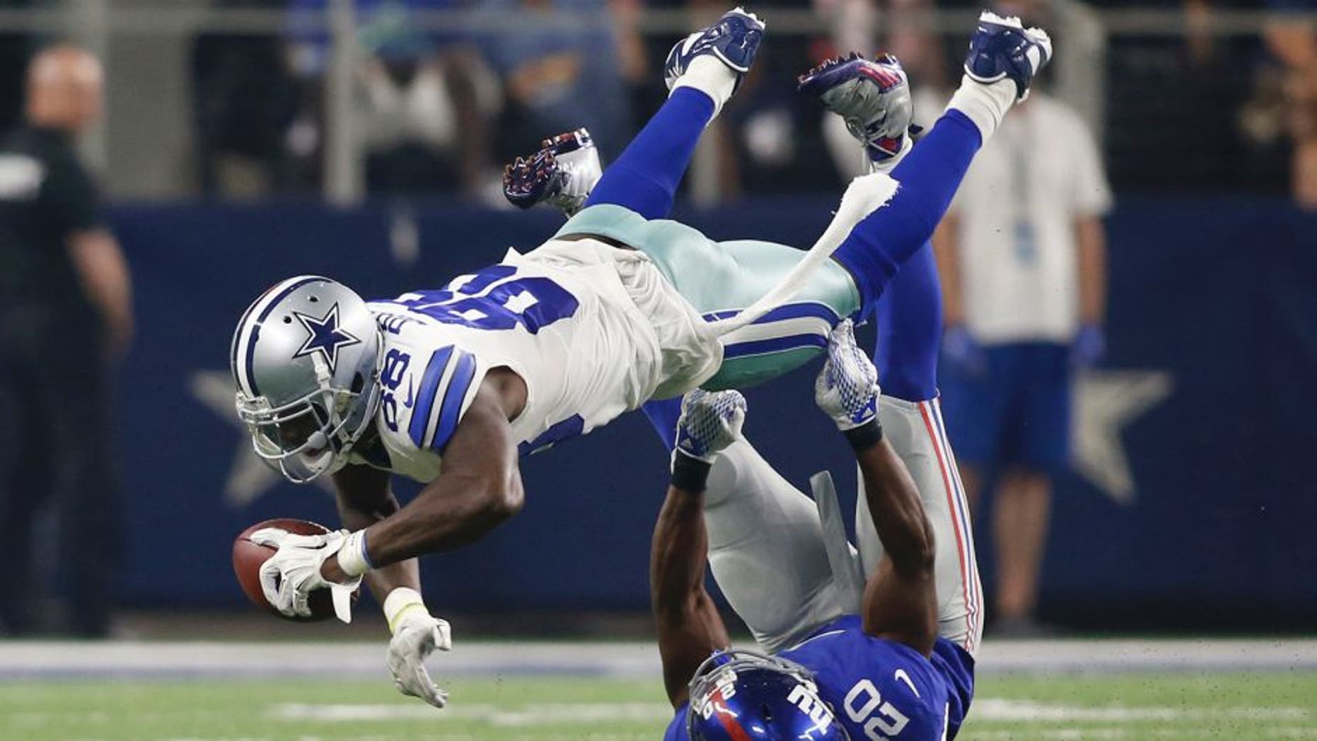 Sep 13, 2015; Arlington, TX, USA; Dallas Cowboys wide receiver Dez Bryant (88) catches the ball as New York Giants cornerback Prince Amukamara (20) tackles at AT&T Stadium. The Cowboys won 27-26. Mandatory Credit: Tim Heitman-USA TODAY Sports