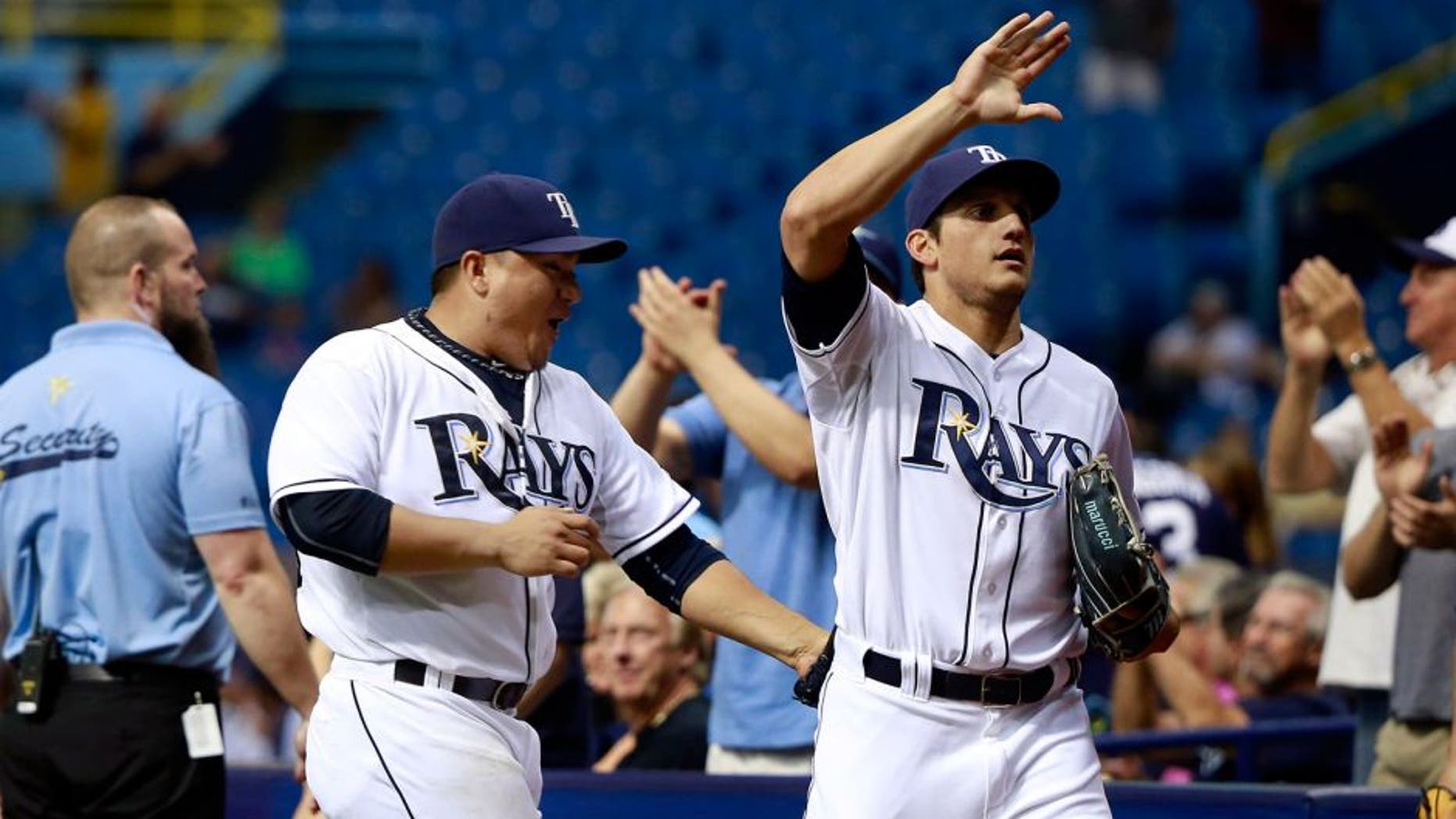 Sep 14, 2015; St. Petersburg, FL, USA; Tampa Bay Rays starting pitcher Erasmo Ramirez (30) high fives Tampa Bay Rays right fielder Mikie Mahtook (27) as he got an unassisted double play to end the seventh inning against the New York Yankees at Tropicana Field. Mandatory Credit: Kim Klement-USA TODAY Sports