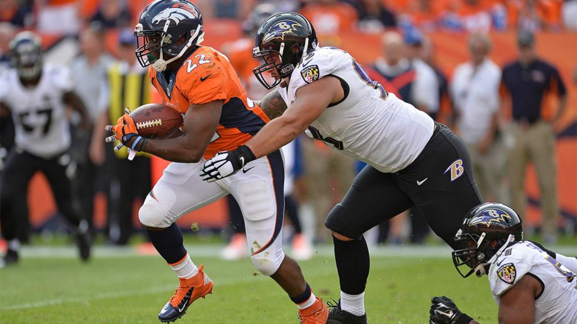 zSep 13, 2015; Denver, CO, USA; Denver Broncos running back C.J. Anderson (22) carries the ball as Baltimore Ravens defensive end Lawrence Guy (93) defends in the fourth quarter at Sports Authority Field at Mile High. The Broncos defeated the Ravens 19-13. Mandatory Credit: Ron Chenoy-USA TODAY Sports