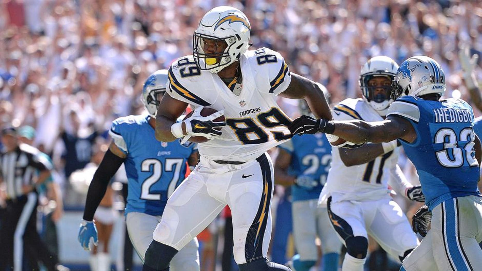 Sep 13, 2015; San Diego, CA, USA; San Diego Chargers tight end Ladarius Green (89) scores during the fourth quarter as Detroit Lions strong safety James Ihedigbo (32) defends at Qualcomm Stadium. Mandatory Credit: Jake Roth-USA TODAY Sports