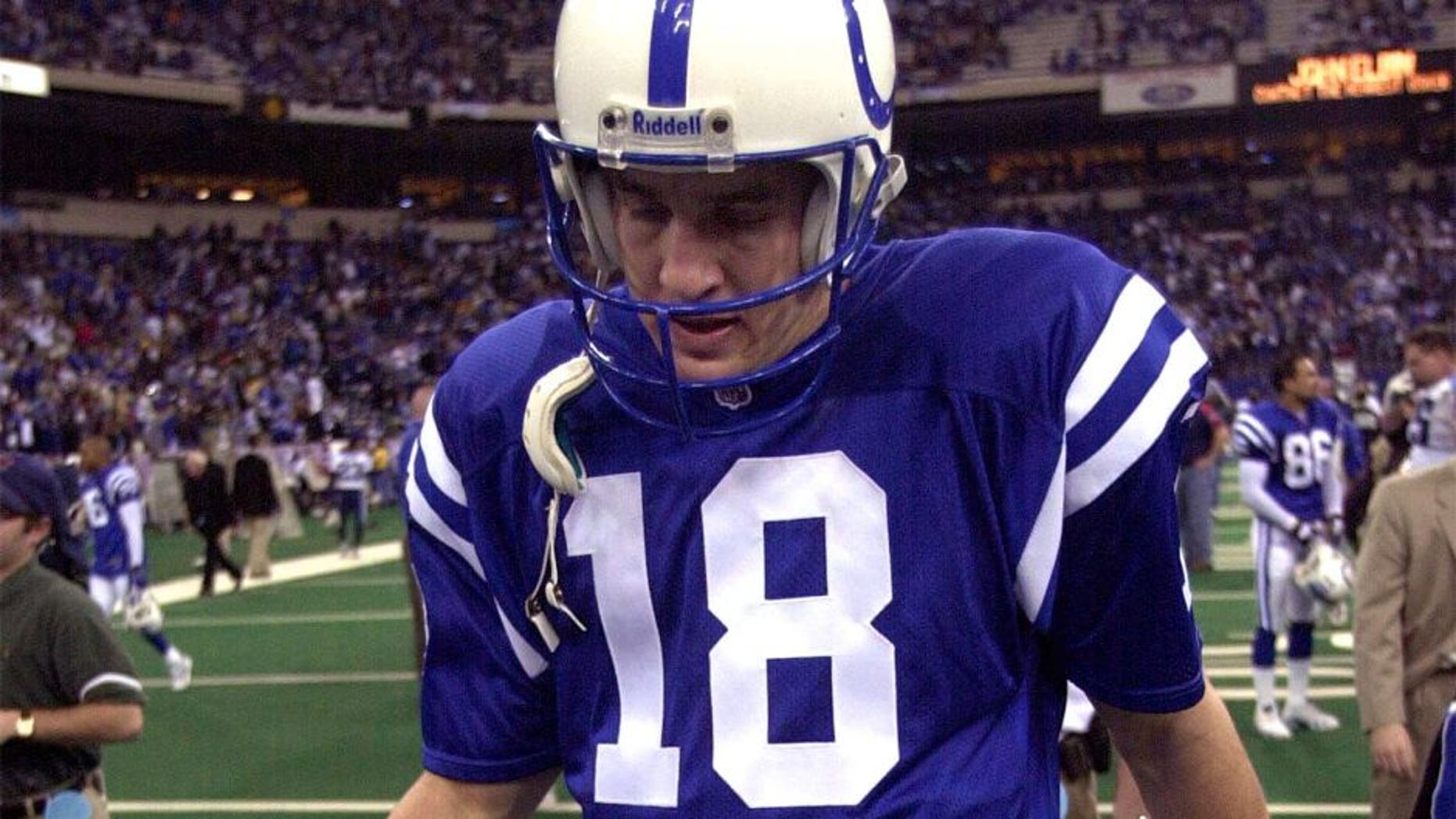 INDIANAPOLIS, UNITED STATES: Indianapolis Colts' quarterback Peyton Manning walks off of the field after their 19-16 loss to the Tennessee Titans during the AFC divisional playoff game on 16 January 2000. AFP PHOTO by Jeff KOWALSKY (Photo credit should read JEFF KOWALSKY/AFP/Getty Images)