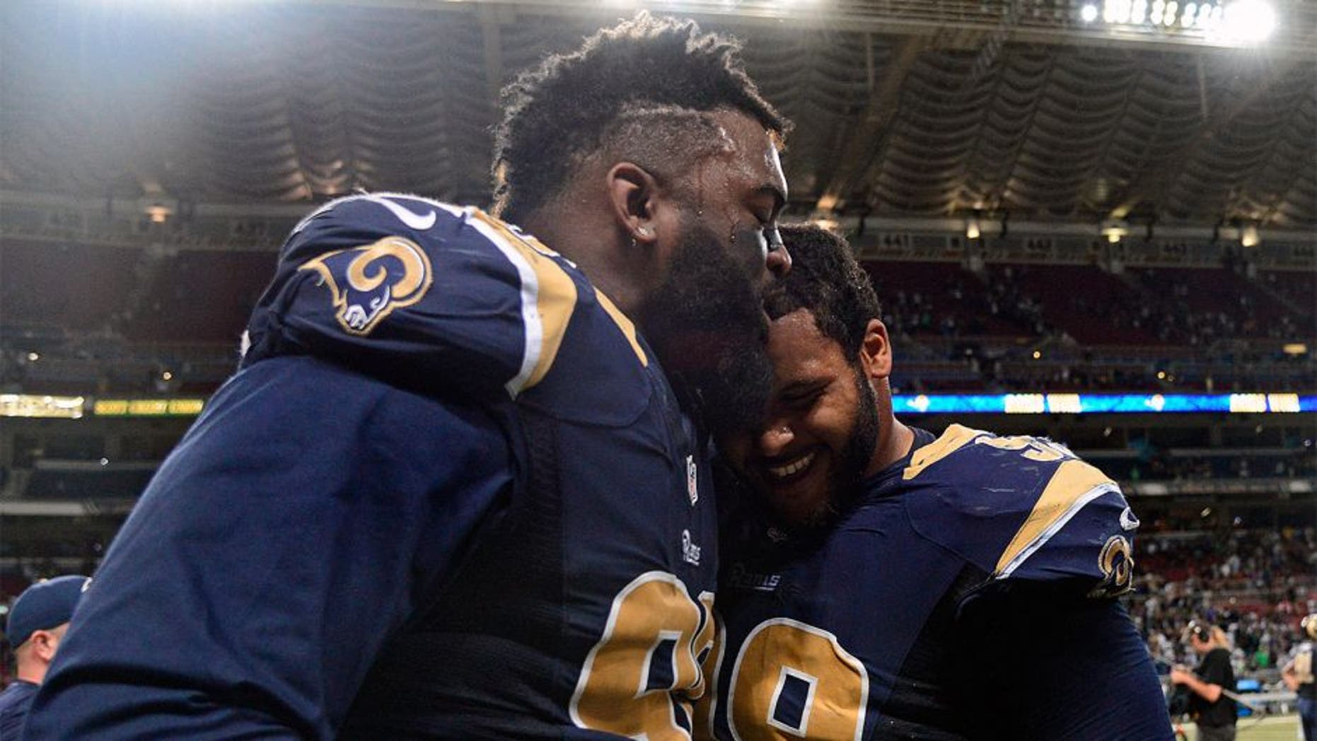 Sep 13, 2015; St. Louis, MO, USA; St. Louis Rams defensive tackle Michael Brockers (90) celebrates with defensive tackle Aaron Donald (99) after defeating the Seattle Seahawks 34-31 in overtime at the Edward Jones Dome. Mandatory Credit: Jeff Curry-USA TODAY Sports