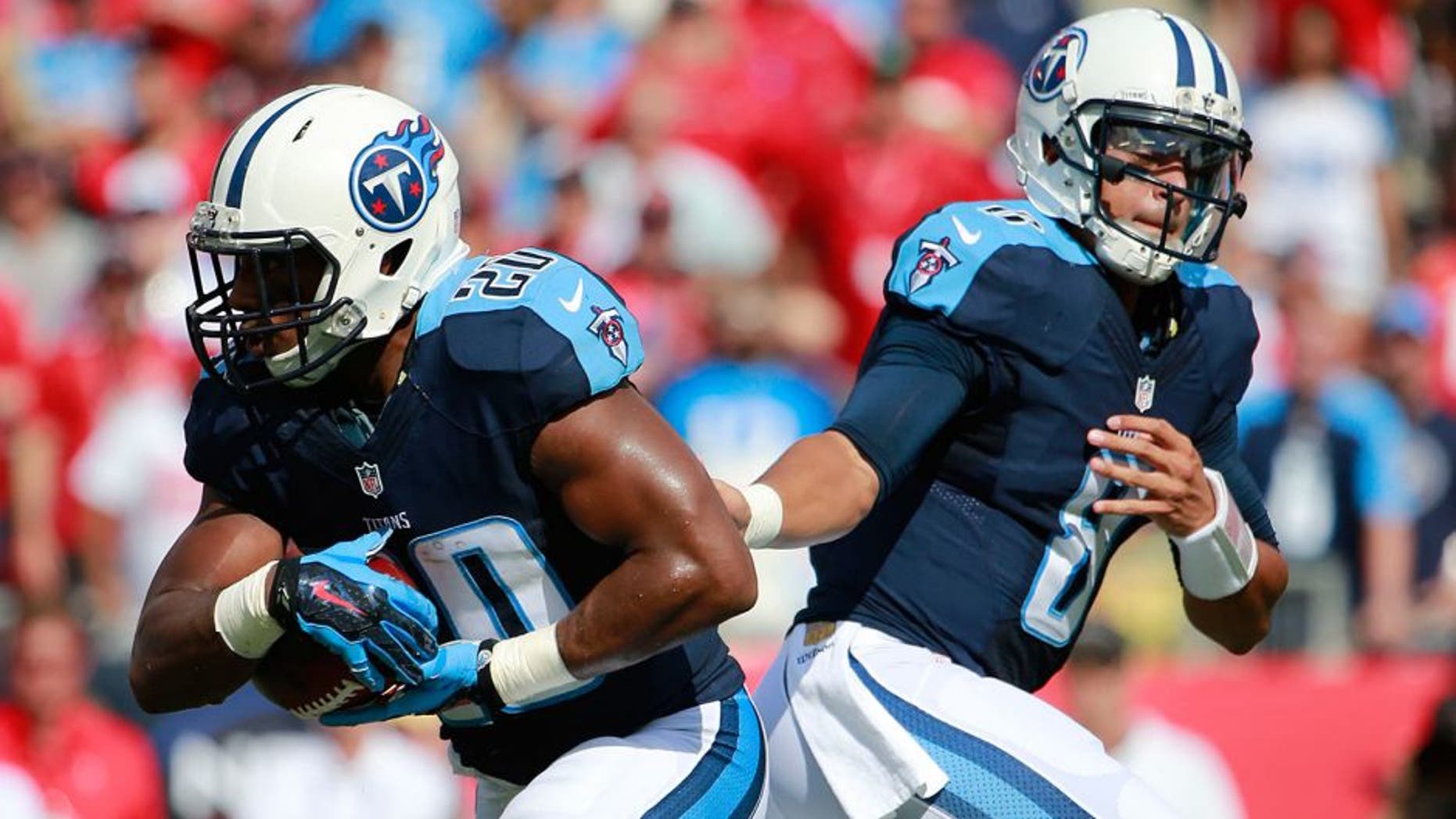 Sep 13, 2015; Tampa, FL, USA; Tennessee Titans quarterback Marcus Mariota (8) hands the ball off to running back Bishop Sankey (20) during the first quarter against the Tampa Bay Buccaneers at Raymond James Stadium. Mandatory Credit: Kim Klement-USA TODAY Sports