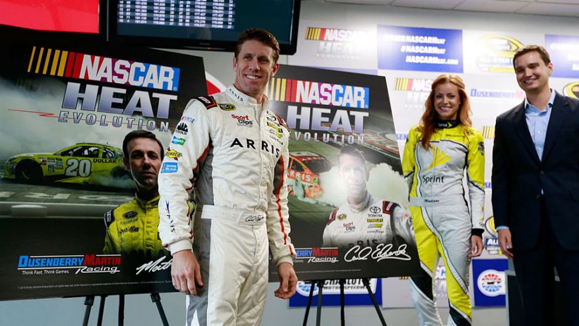 CHARLOTTE, NC - MAY 20: Matt Dusenberry, Director of Partnerships and Revenue at Dusenberry Martin Racing, Carl Edwards, driver of the #19 ARRIS Toyota, and Miss Sprint Cup Madison Martin, speak to the media during a press conference prior to practice for the NASCAR Sprint Cup Series Sprint Showdown at Charlotte Motor Speedway on May 20, 2016 in Charlotte, North Carolina. (Photo by Matt Sullivan/NASCAR via Getty Images)